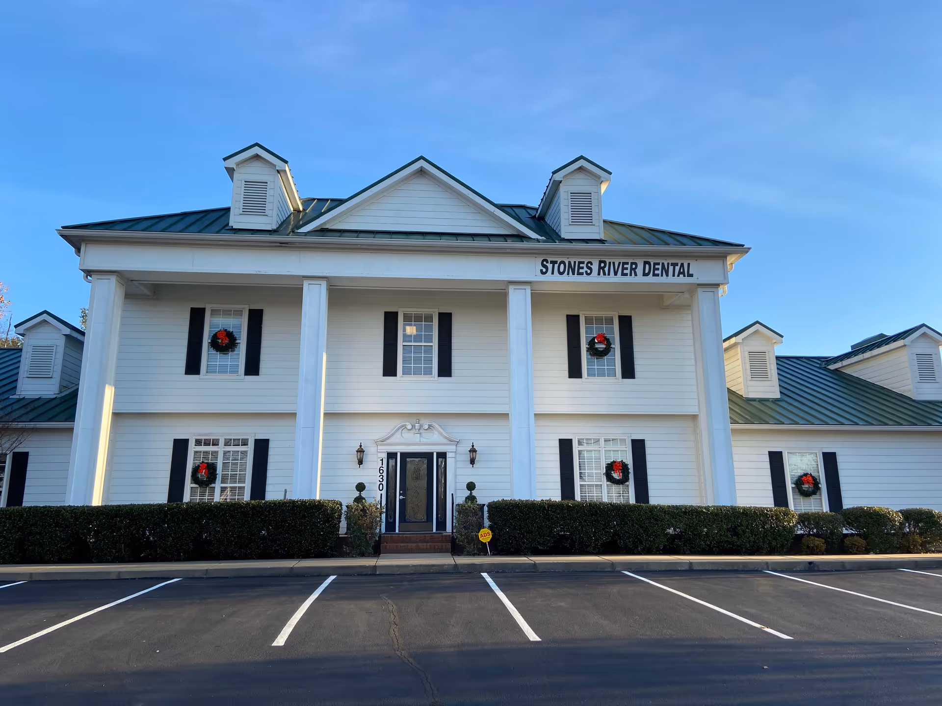 Exterior view of Stones River Dental building with wreaths and front parking.