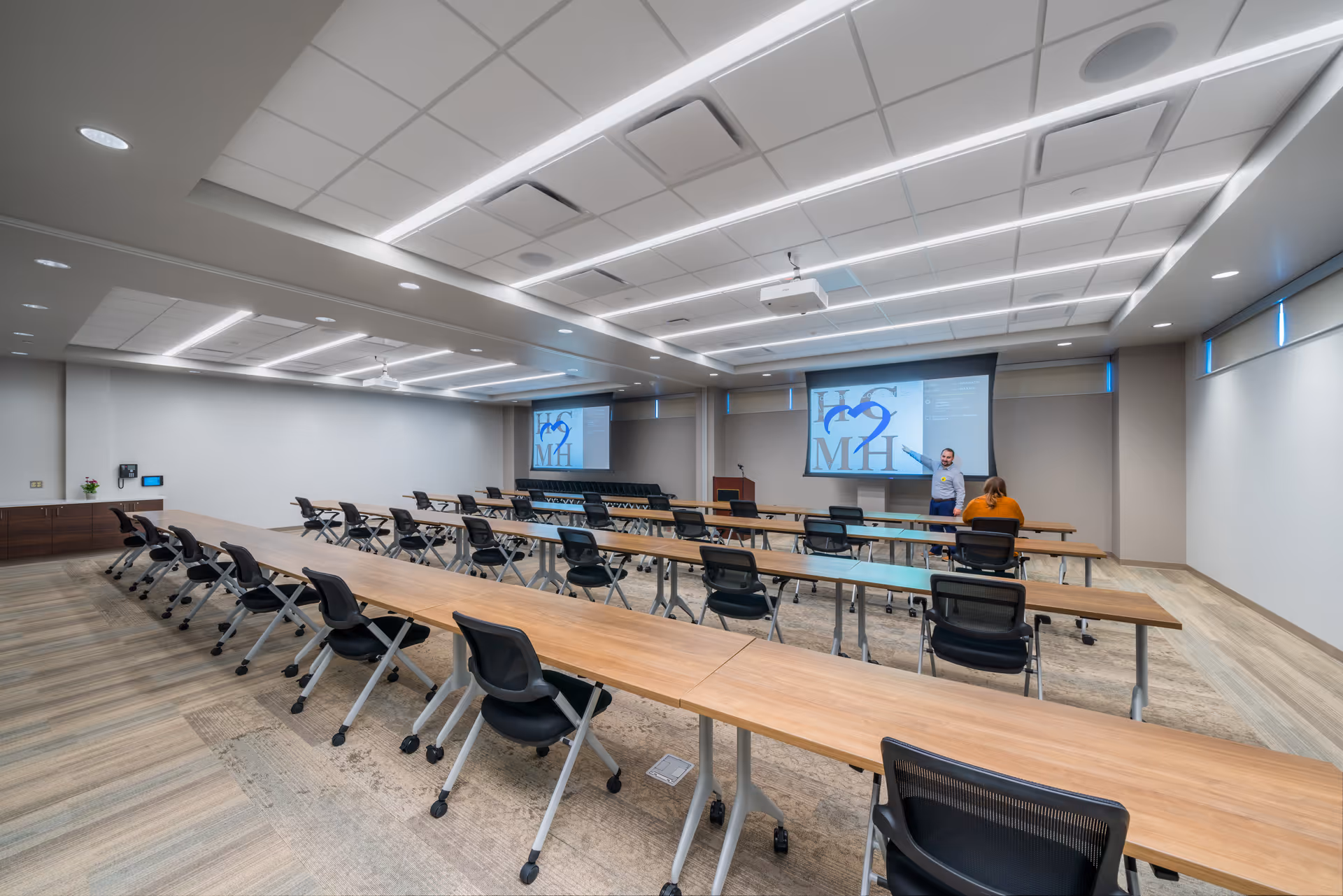 Spacious training room at Humboldt County Memorial Hospital with long desks and projection screens.