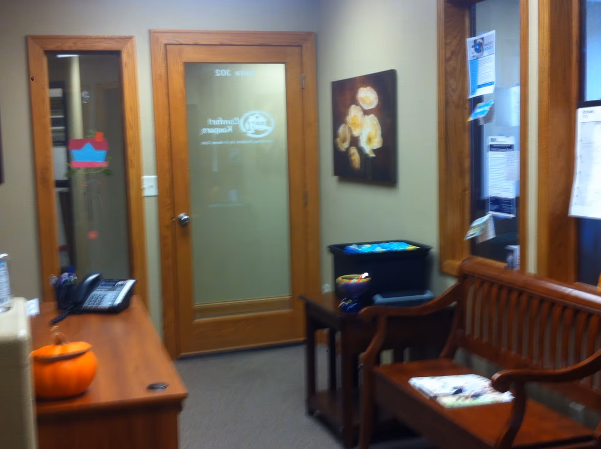 The interior lobby area features wooden doors, bench seating, pumpkin decor, and a bulletin board.