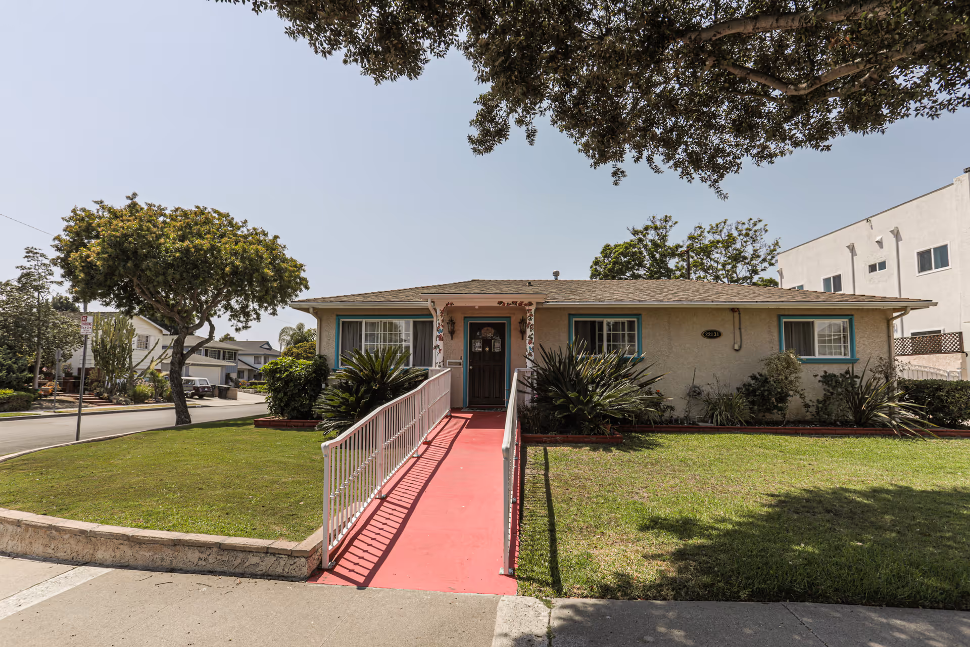 Exterior view of Summerwind Manor Inc, a single-story facility with a red ramp to the entrance.