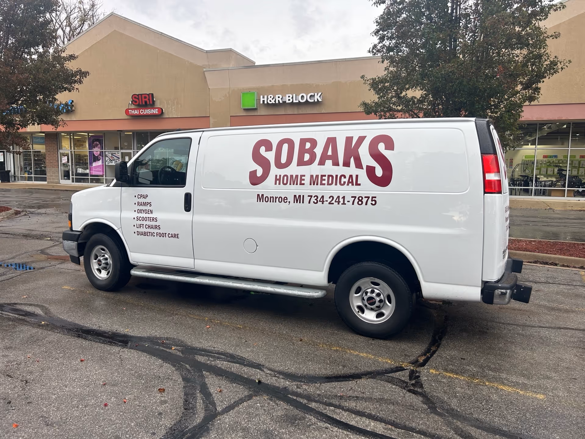 White Sobaks Home Medical van parked in a strip mall lot.