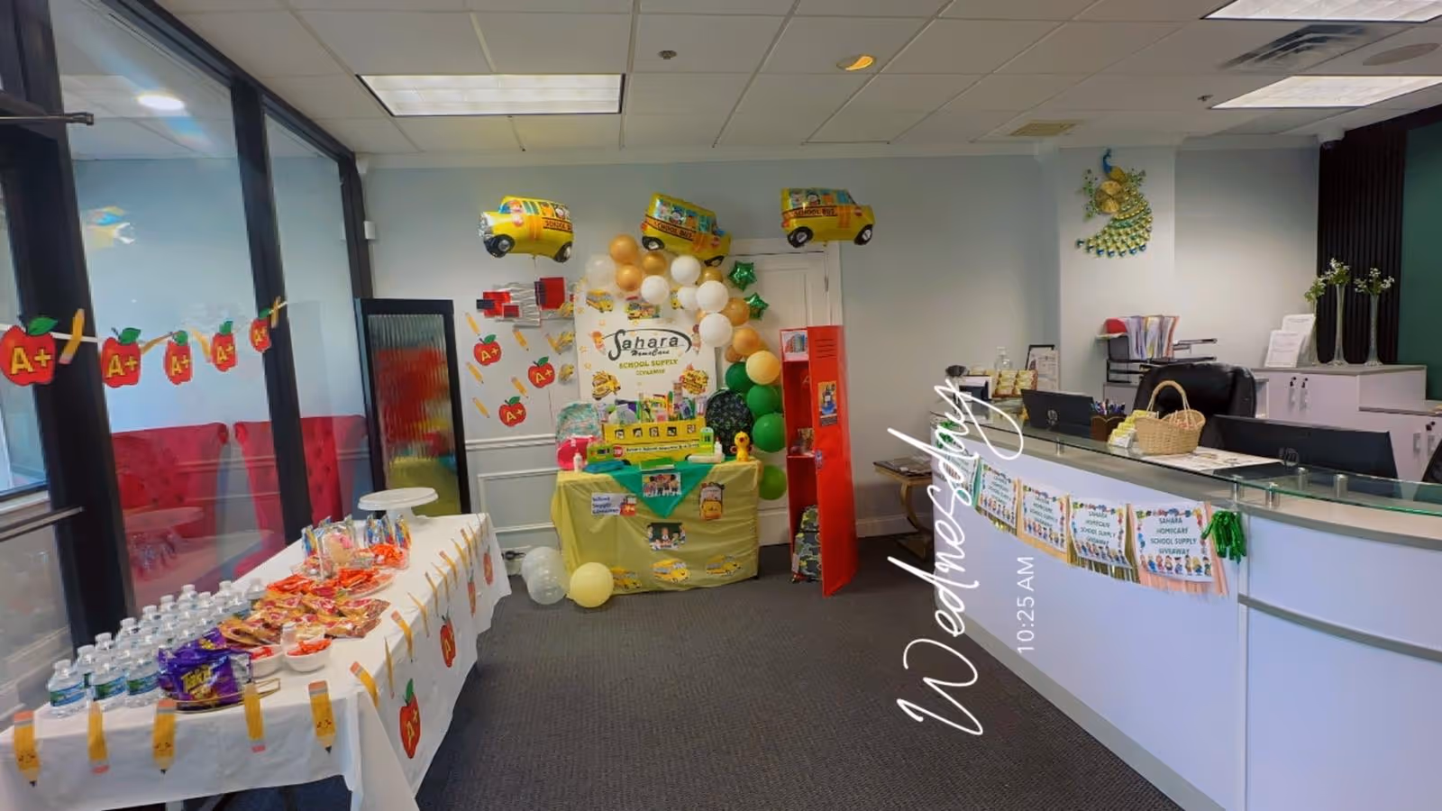 Indoor facility lobby decorated with a table, balloons, snacks, and a Sahara Home Care sign.