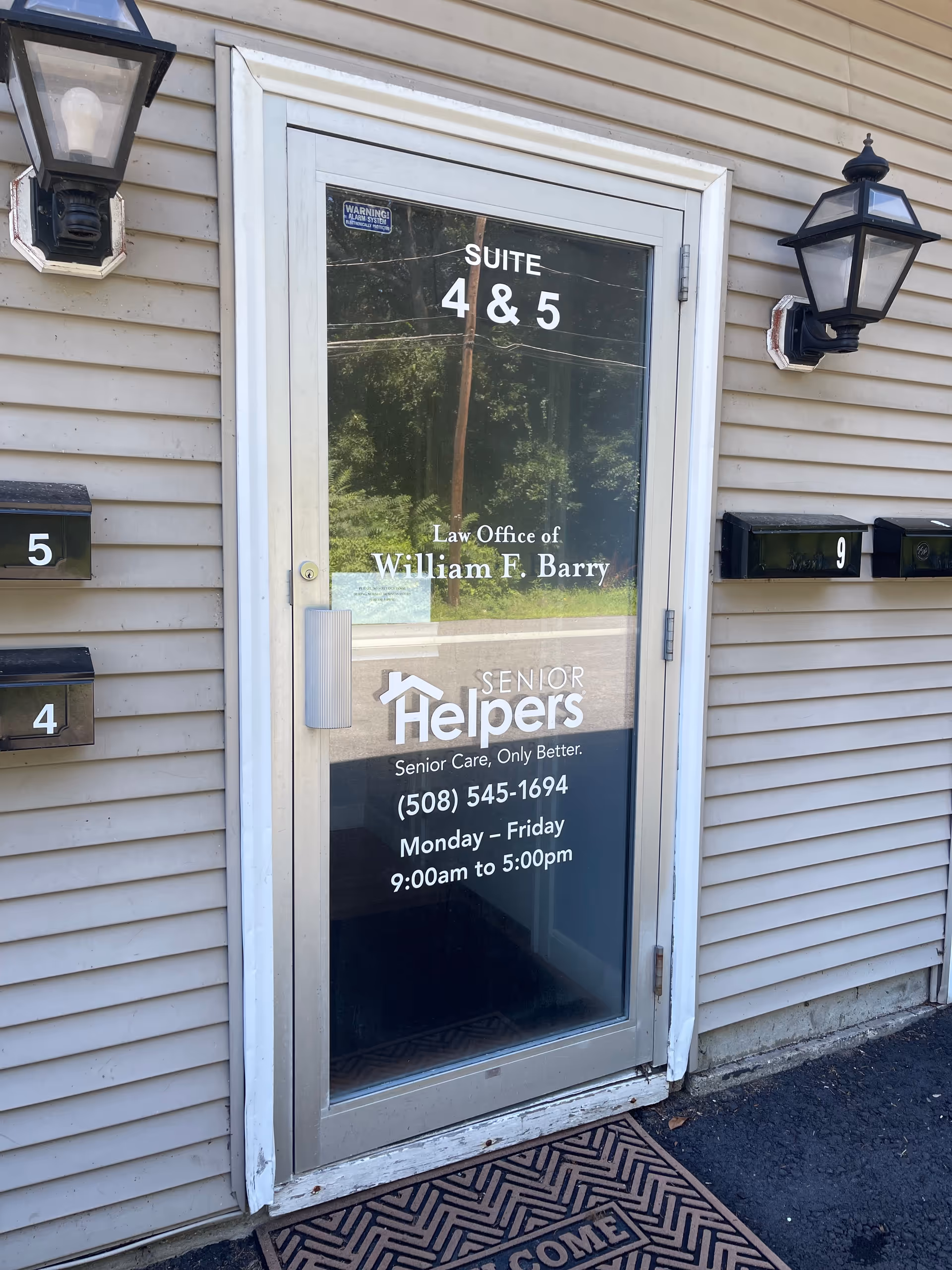 Exterior building doorway with glass door labeled Suite 4 & 5 and Senior Helpers signage.