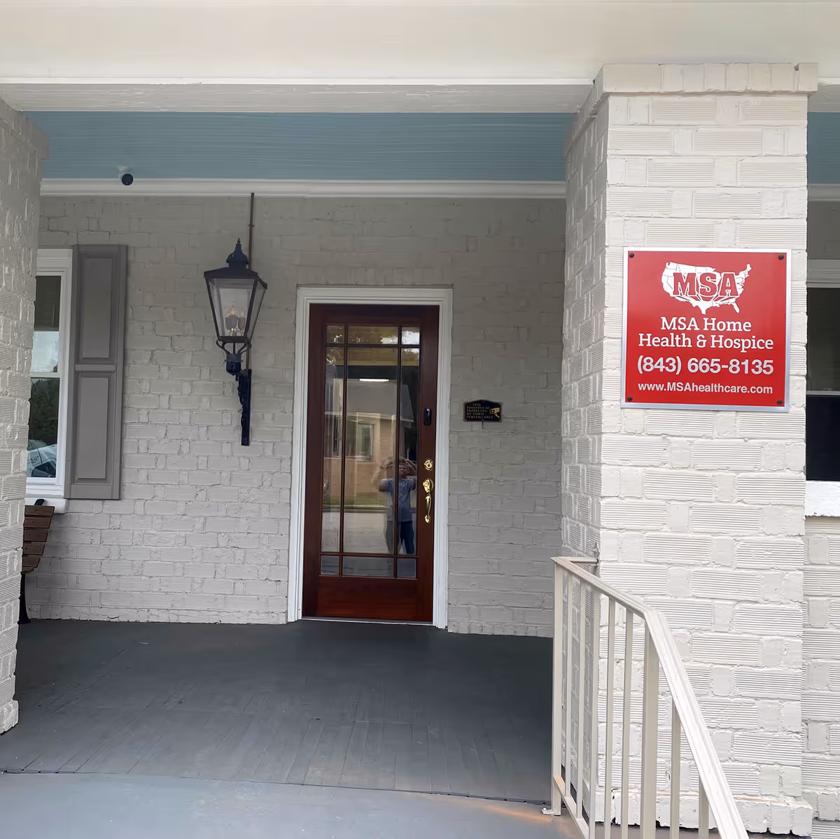 Front entrance of a white brick building with an MSA Home Health and Hospice sign.