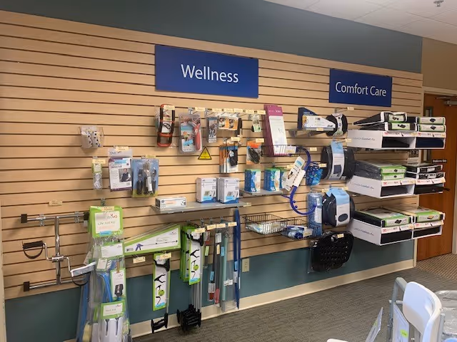Interior wall displaying wellness supplies and medical devices under Wellness and Comfort Care signs.