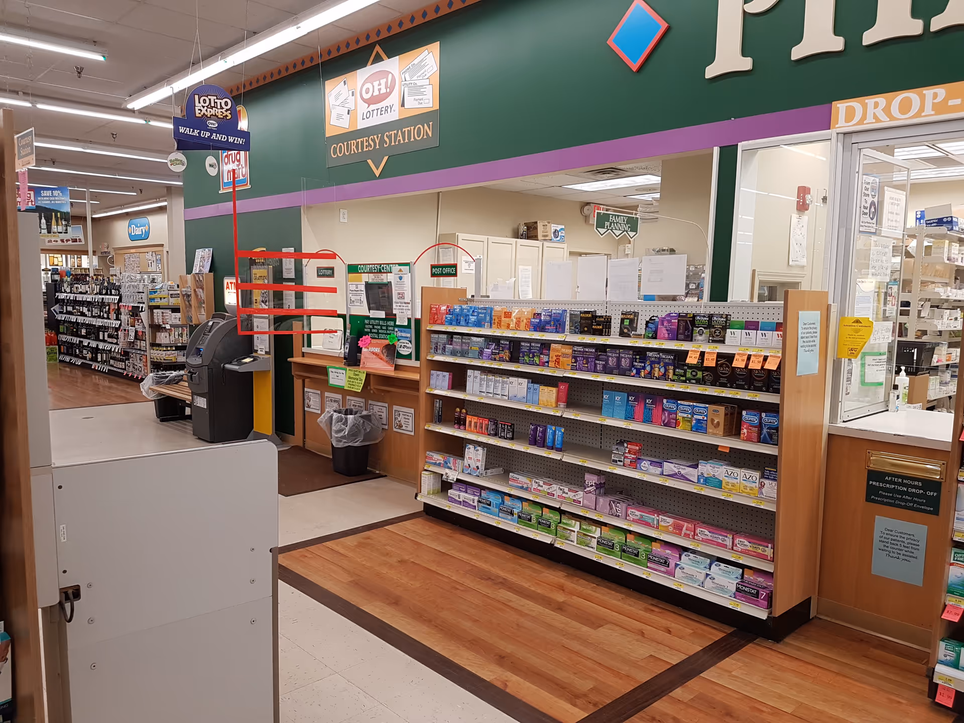 Interior of Discount Drug Mart showing checkout area, shelves, and signage