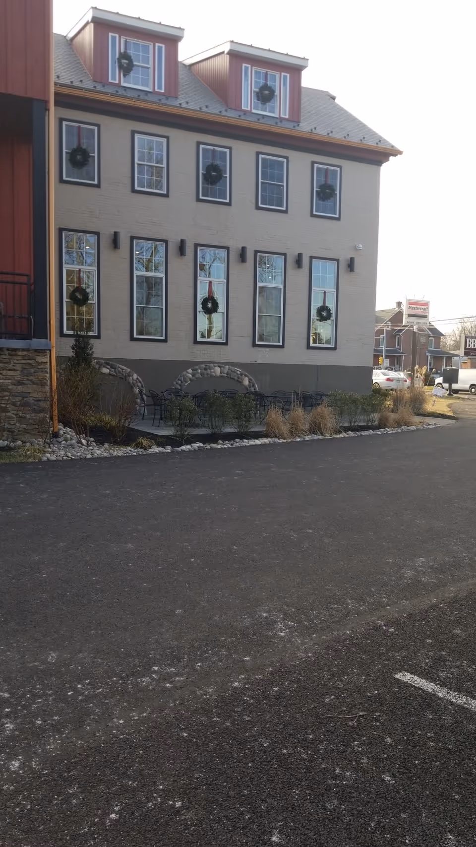 Exterior view of BAYADA Pediatrics building with wreaths on windows and outdoor seating.