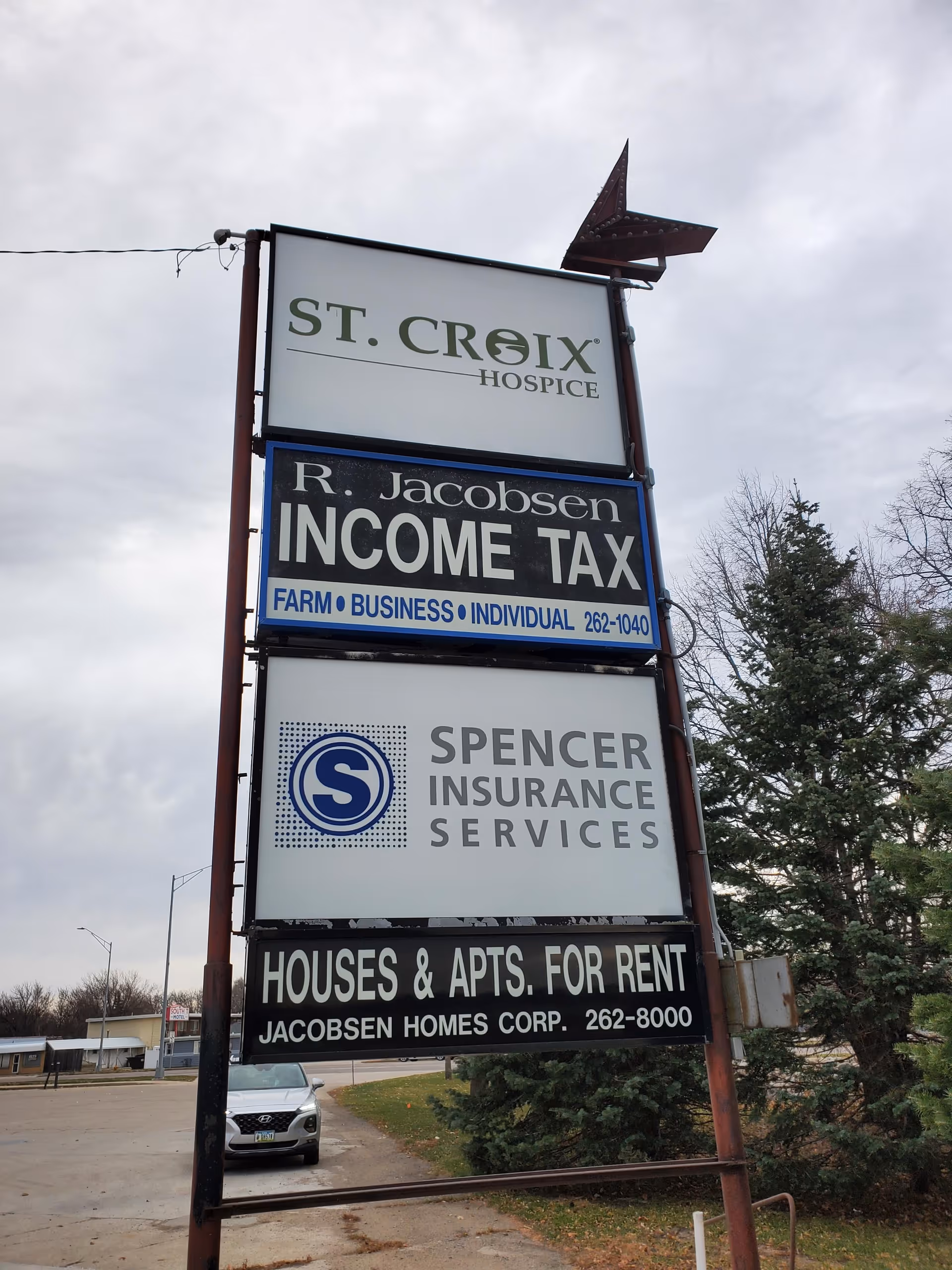 Outdoor street sign display for St. Croix Hospice with other business signs.