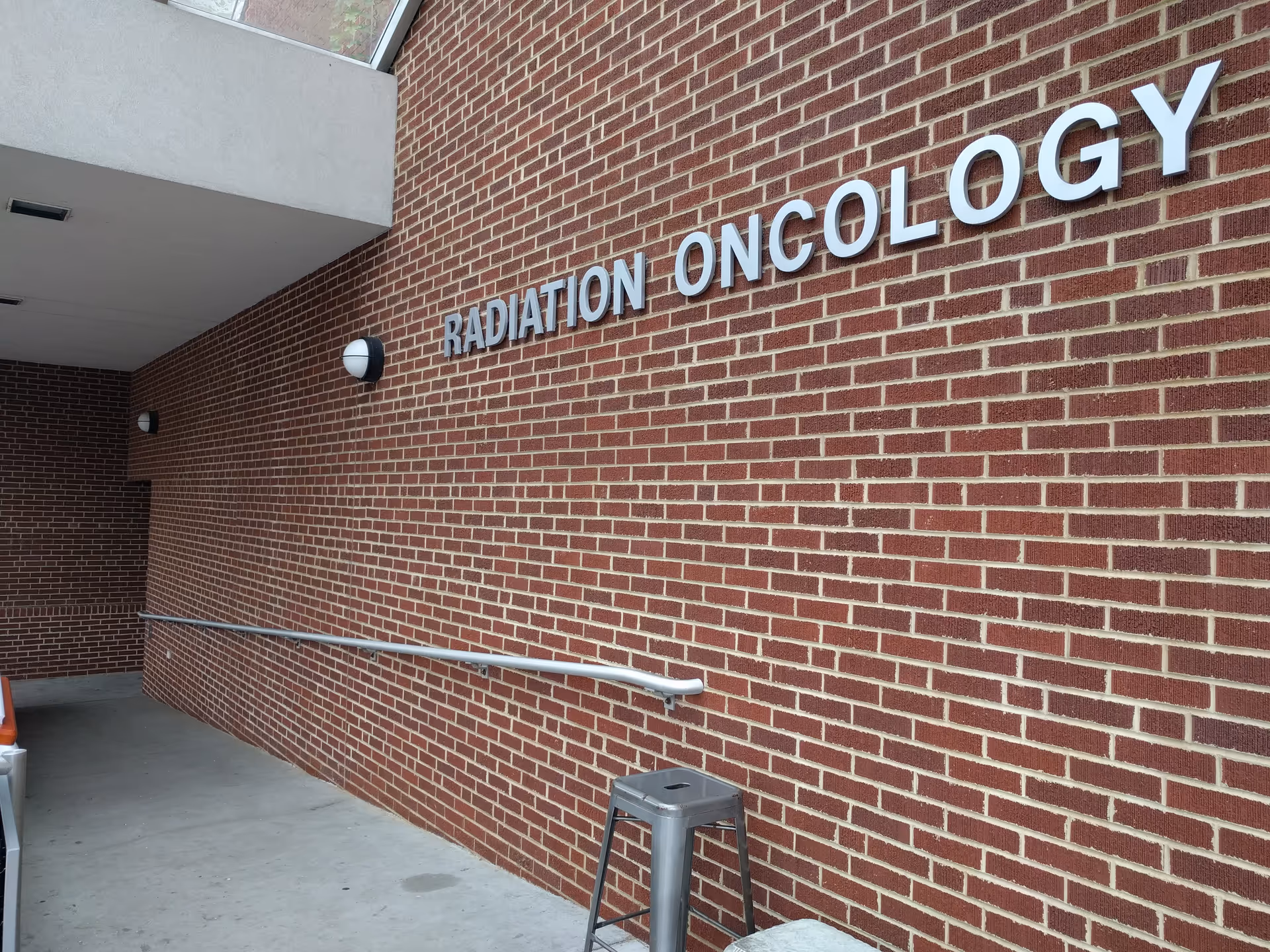 Brick exterior wall with a Radiation Oncology sign on a medical center.