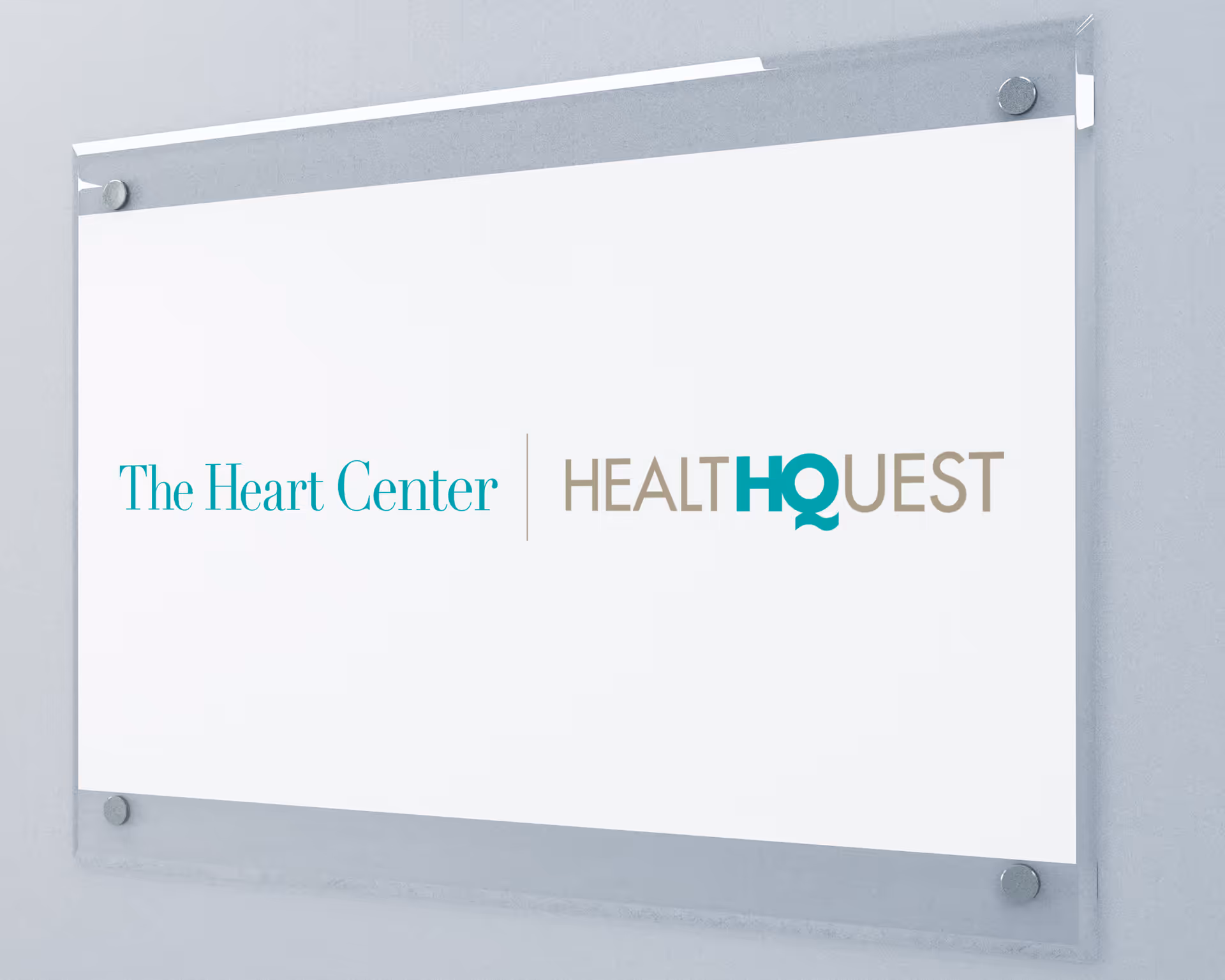 A wall-mounted sign showing The Heart Center and HealthQuest logos.