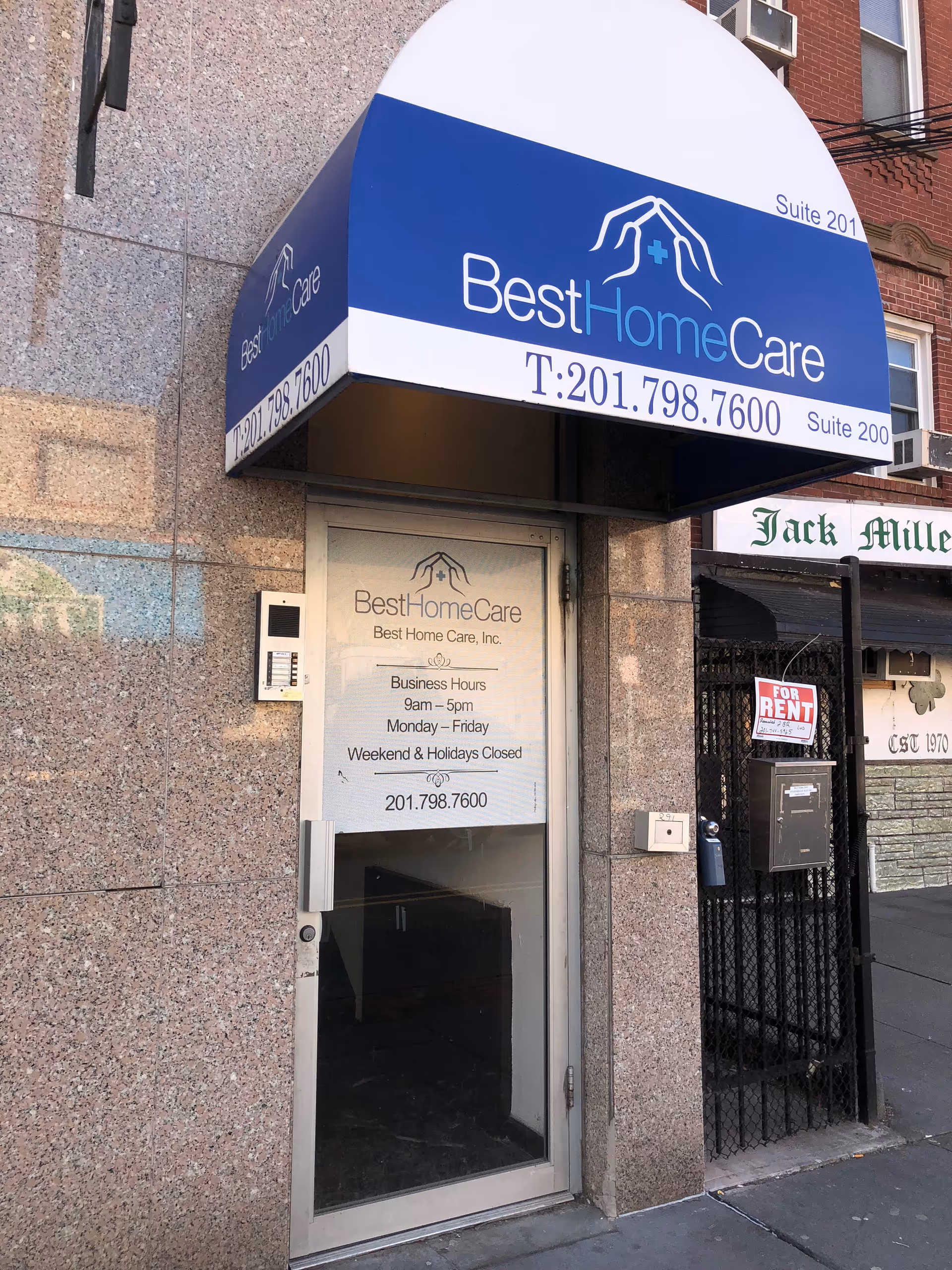 Blue Best Home Care awning above the entrance storefront on a textured building.