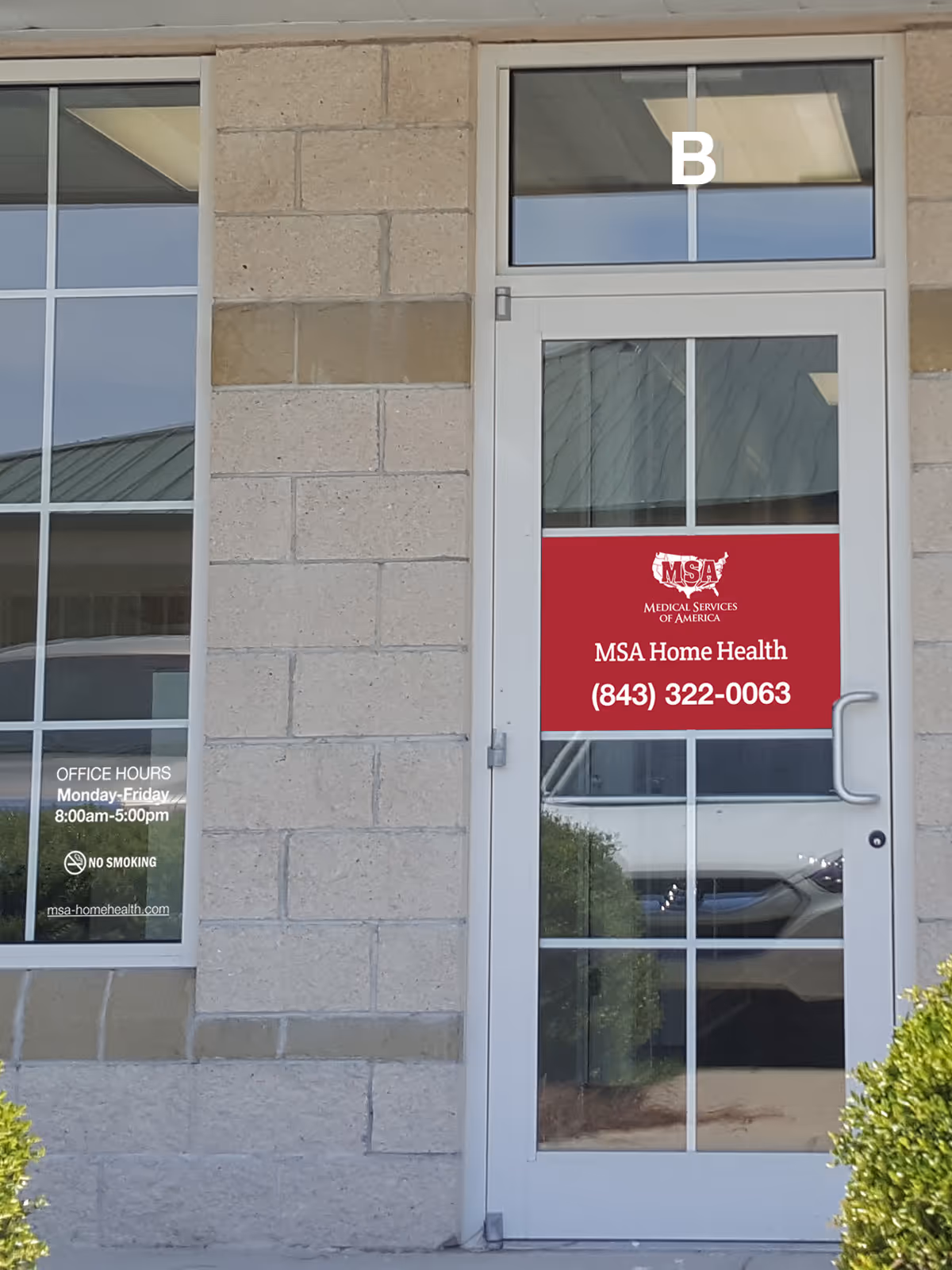 Entrance to MSA Home Health building with glass door and red sign.
