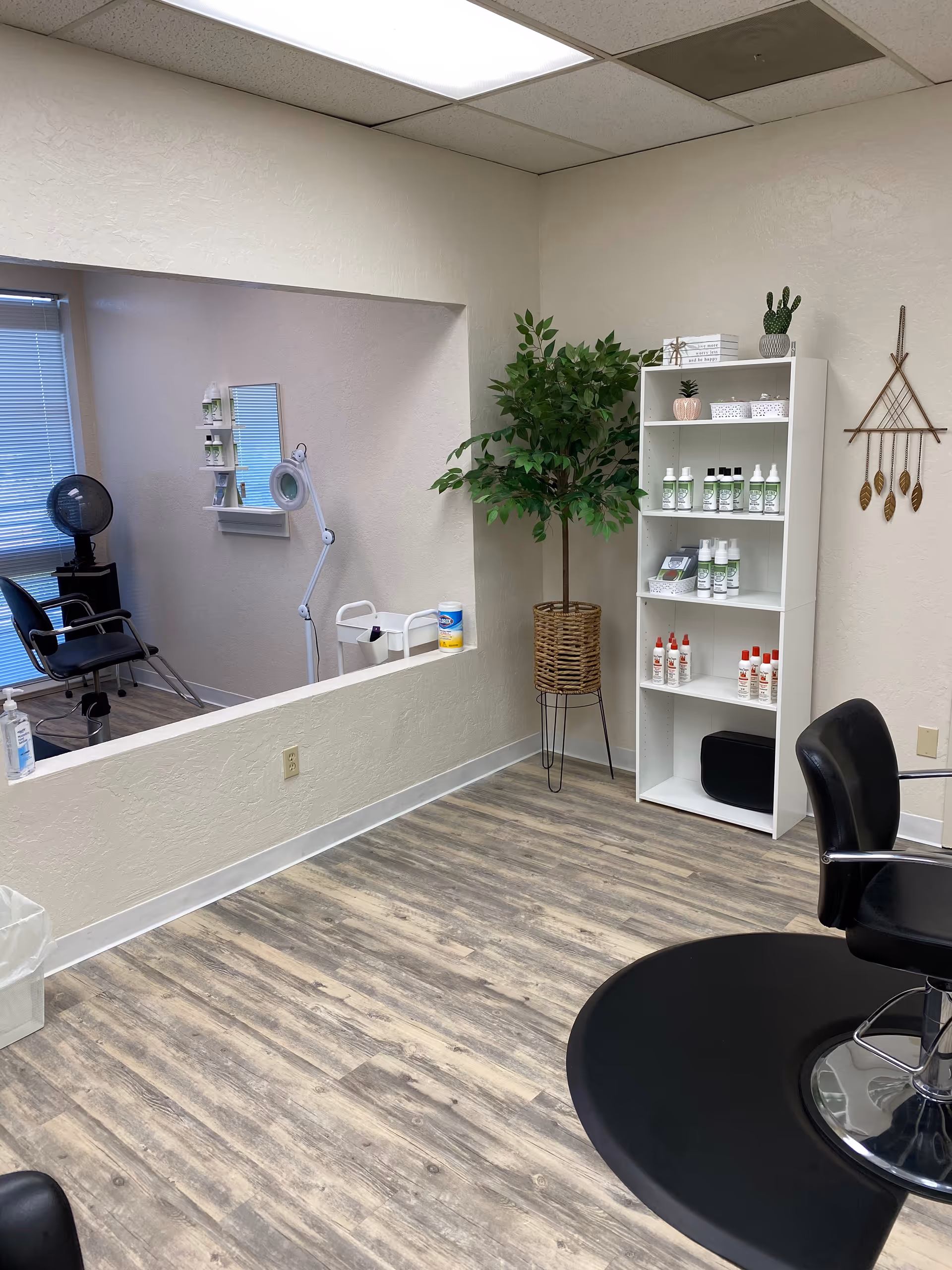 Interior view of a senior living salon with chairs, shelves, and a plant.