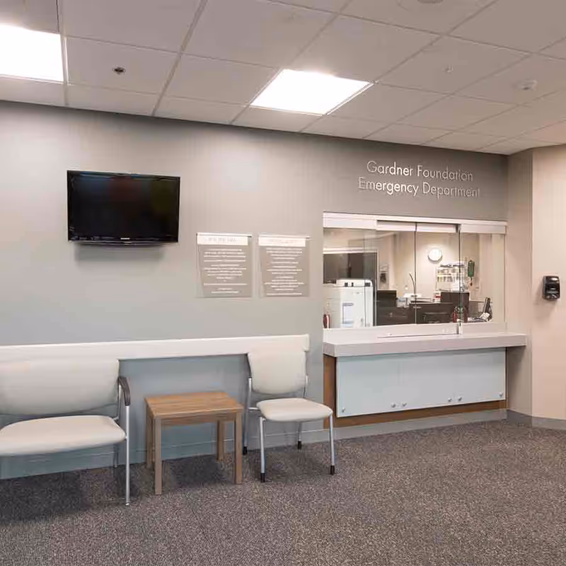 Interior of Providence Medical Center Emergency Department with waiting area chairs and a windowed counter.