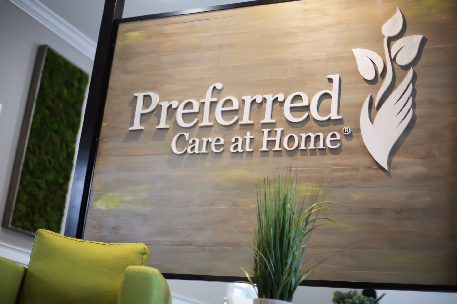 Interior lobby featuring a large Preferred Care at Home sign on a wood wall