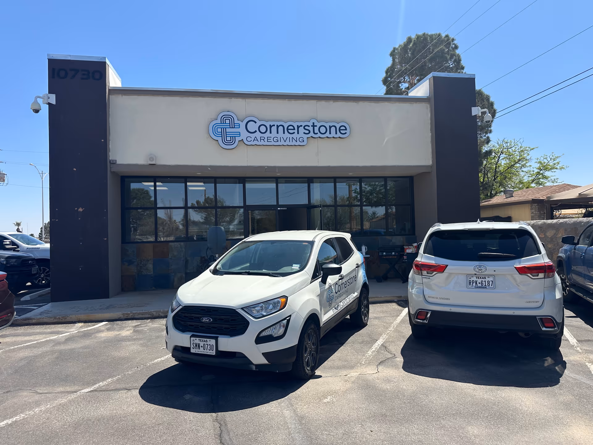 Front view of Cornerstone Caregiving building with two parked cars in the lot.