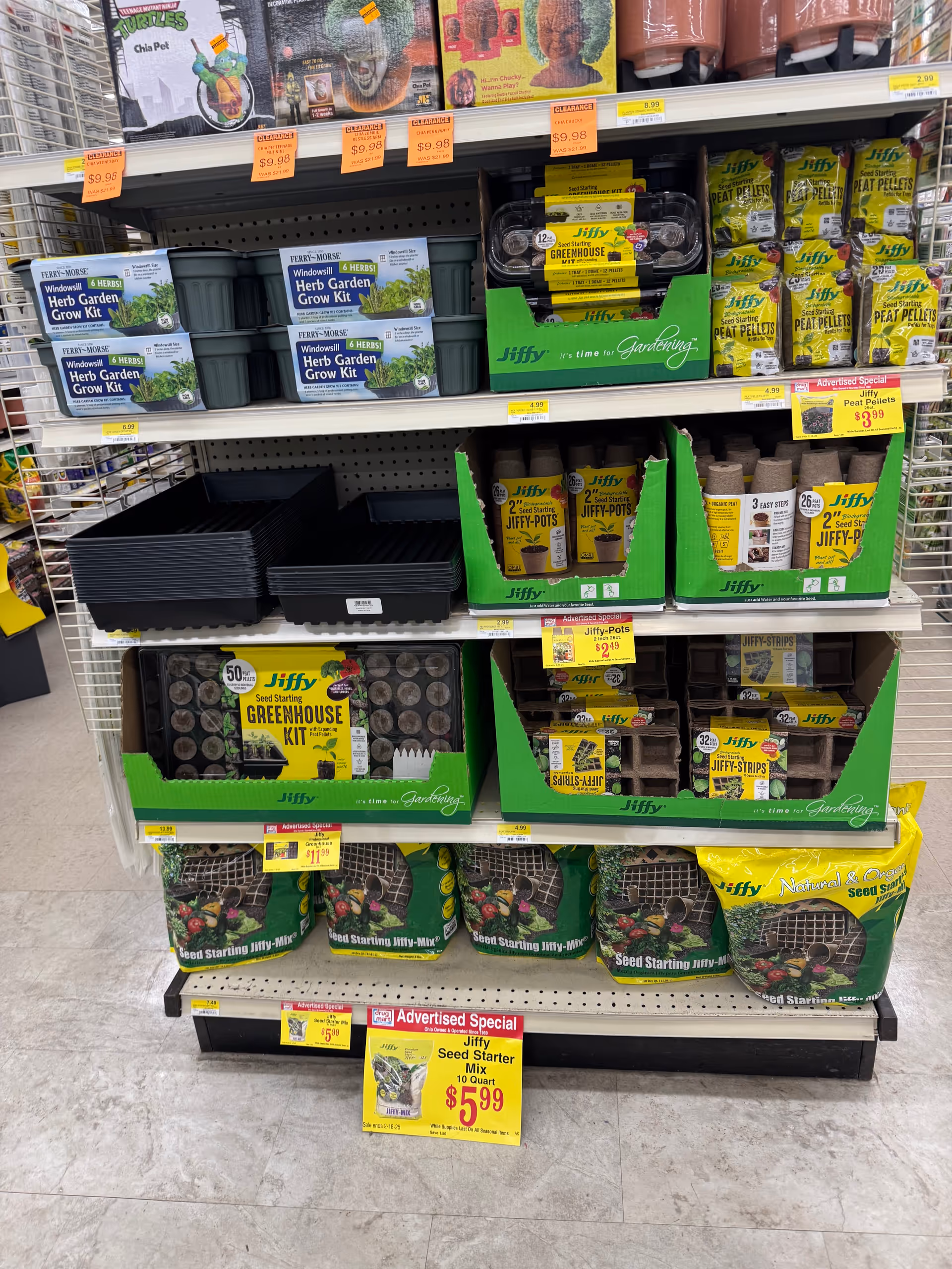 Interior of Discount Drug Mart displaying gardening kits and seed packets on shelves.