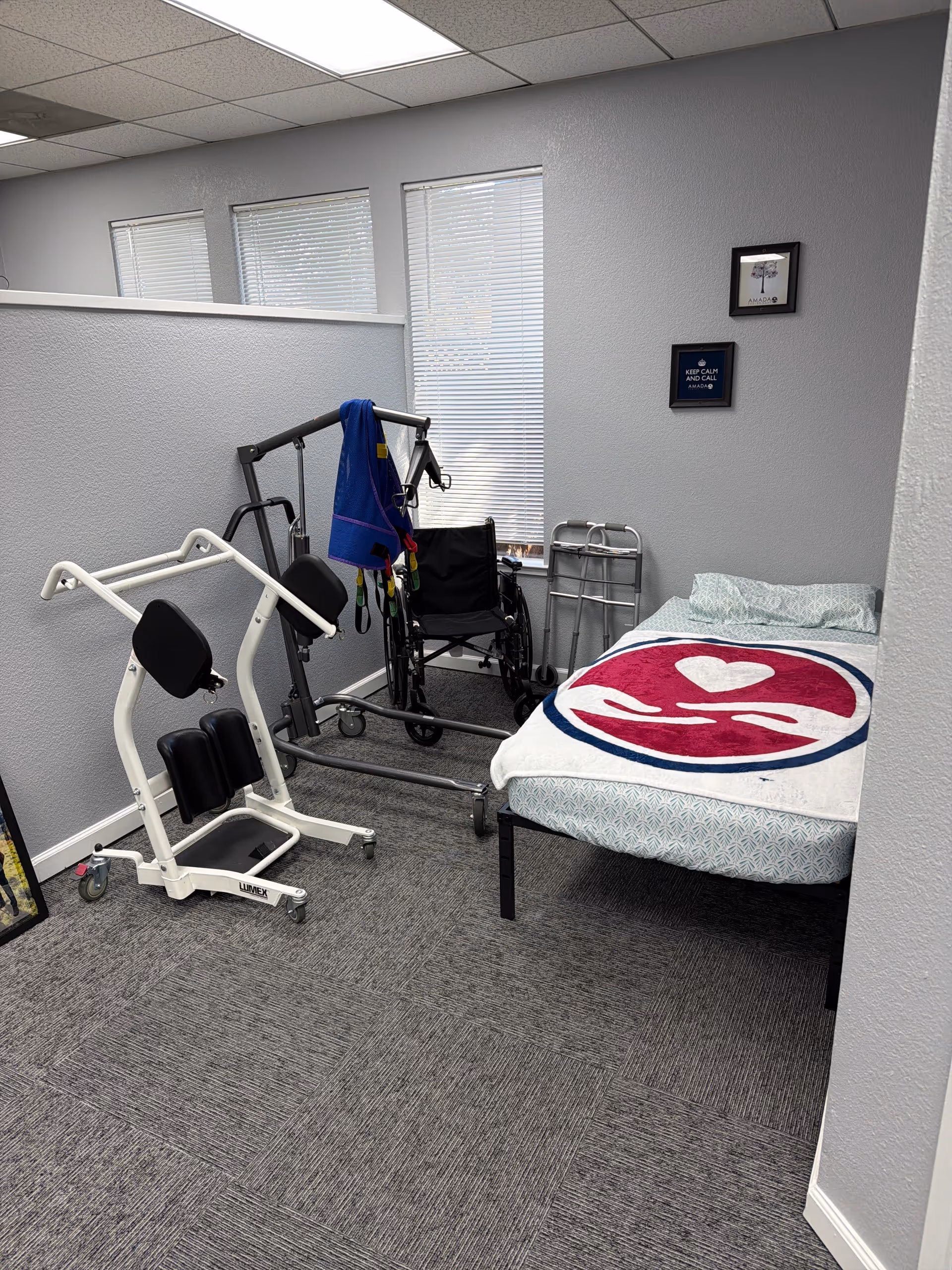 Indoor senior care room with a bed, wheelchair, and rehabilitation equipment.