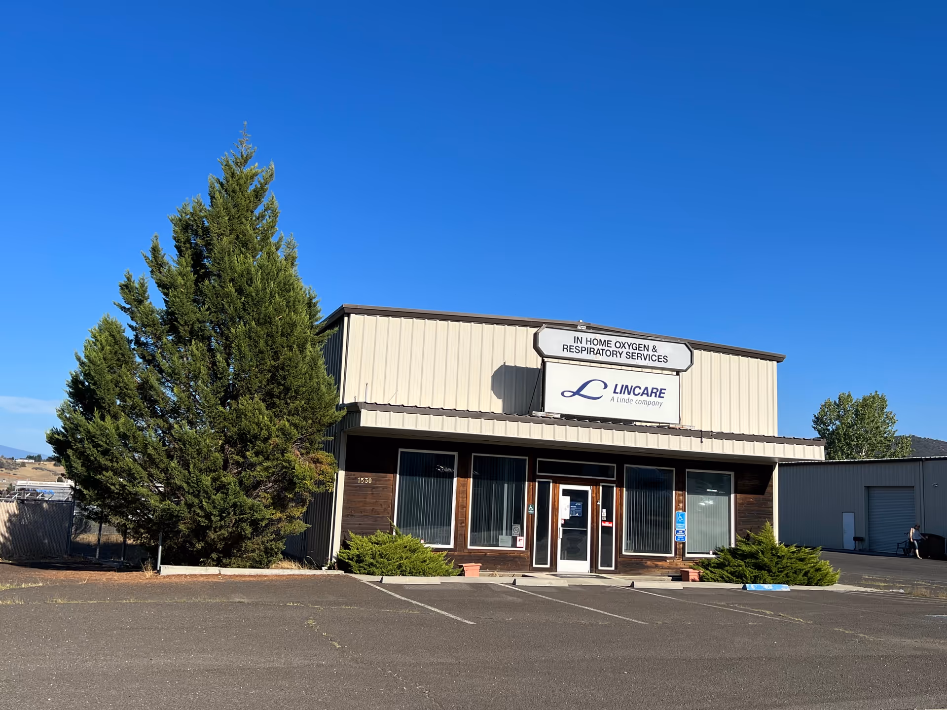 Front view of LINCARE building with signage and a parking lot.
