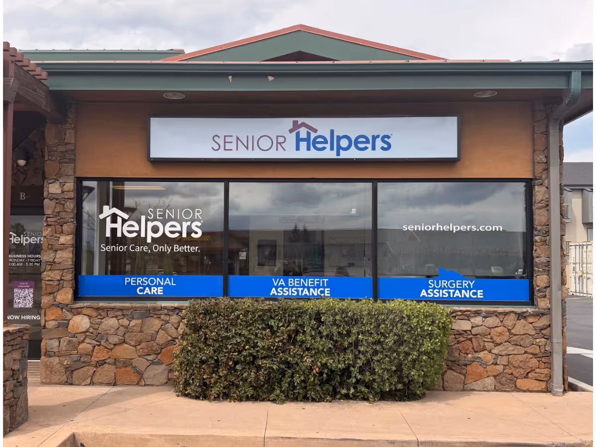 Exterior view of Senior Helpers storefront with stone facade and blue signage.