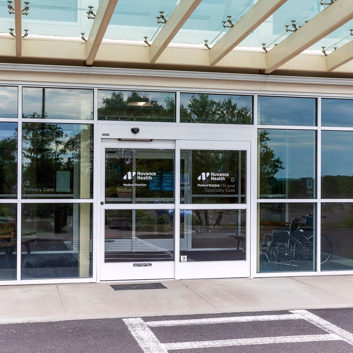 Glass storefront entrance with Nuvance Health signage; a wheelchair is visible inside.