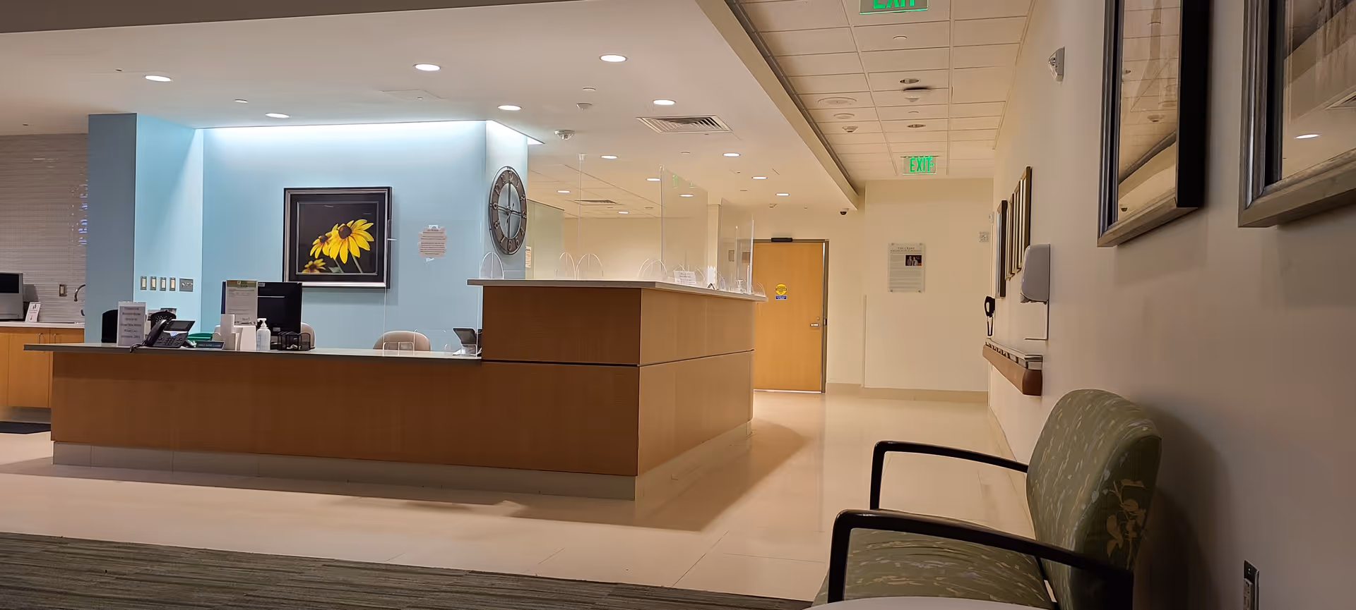 Reception desk in a bright Mercy Medical Center lobby with seating along the wall