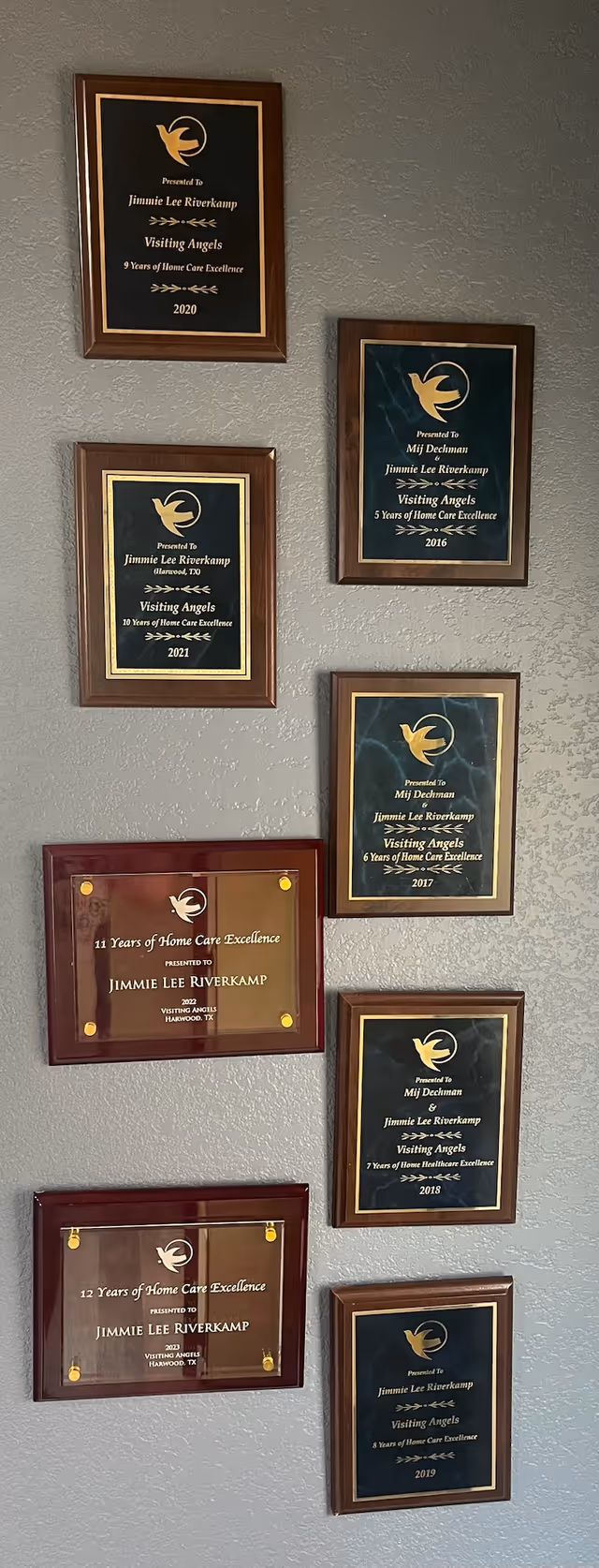 Wall displays multiple framed awards and plaques for Visiting Angels Senior Home Care.