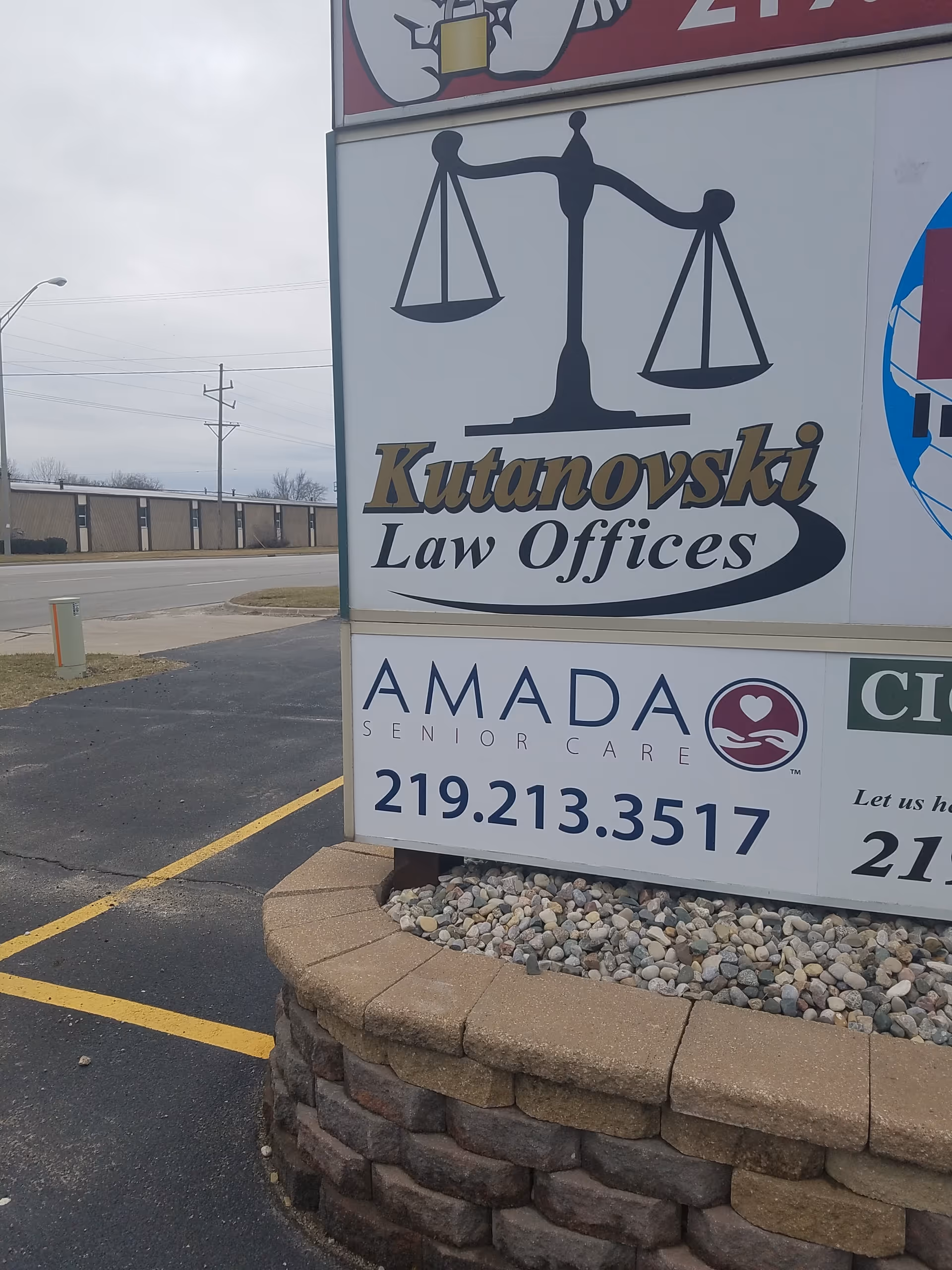 A roadside sign shows Kutanovski Law Offices and Amada Senior Care logos.