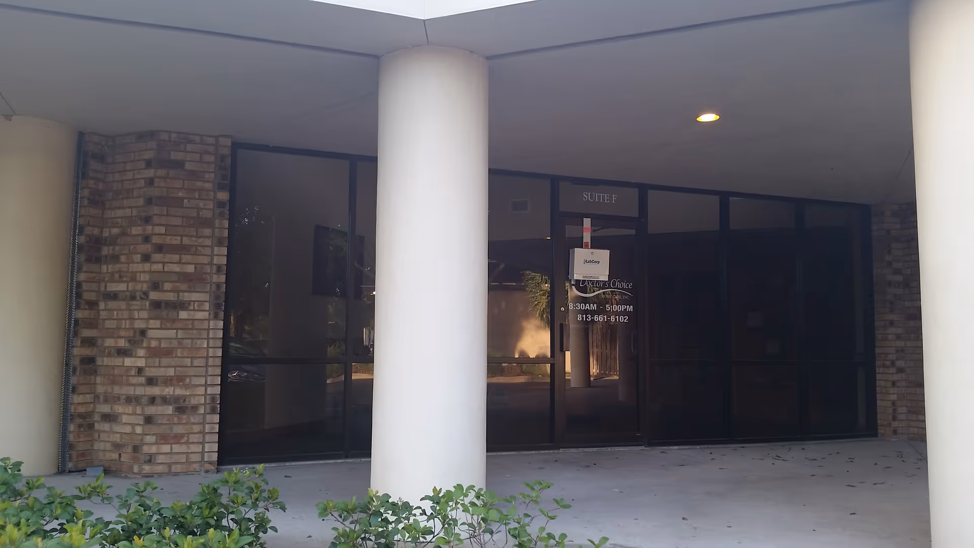 Exterior view of Aveanna Home Health entrance with glass doors under a covered walkway