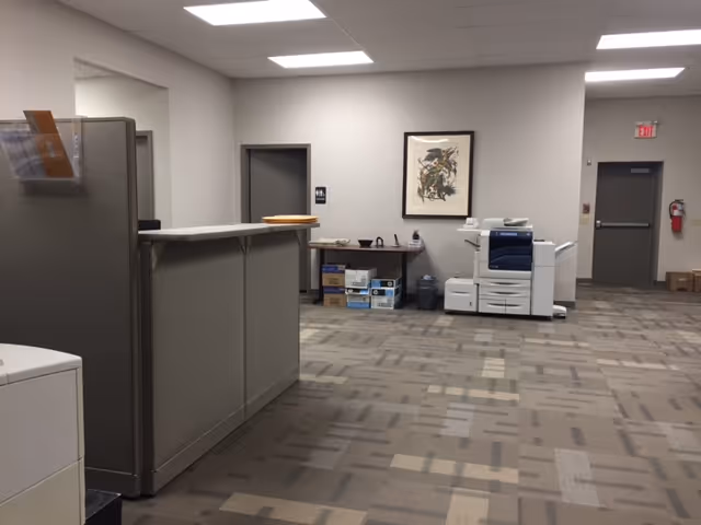 This care facility lobby shows a cubicle desk, printer, and office supplies.