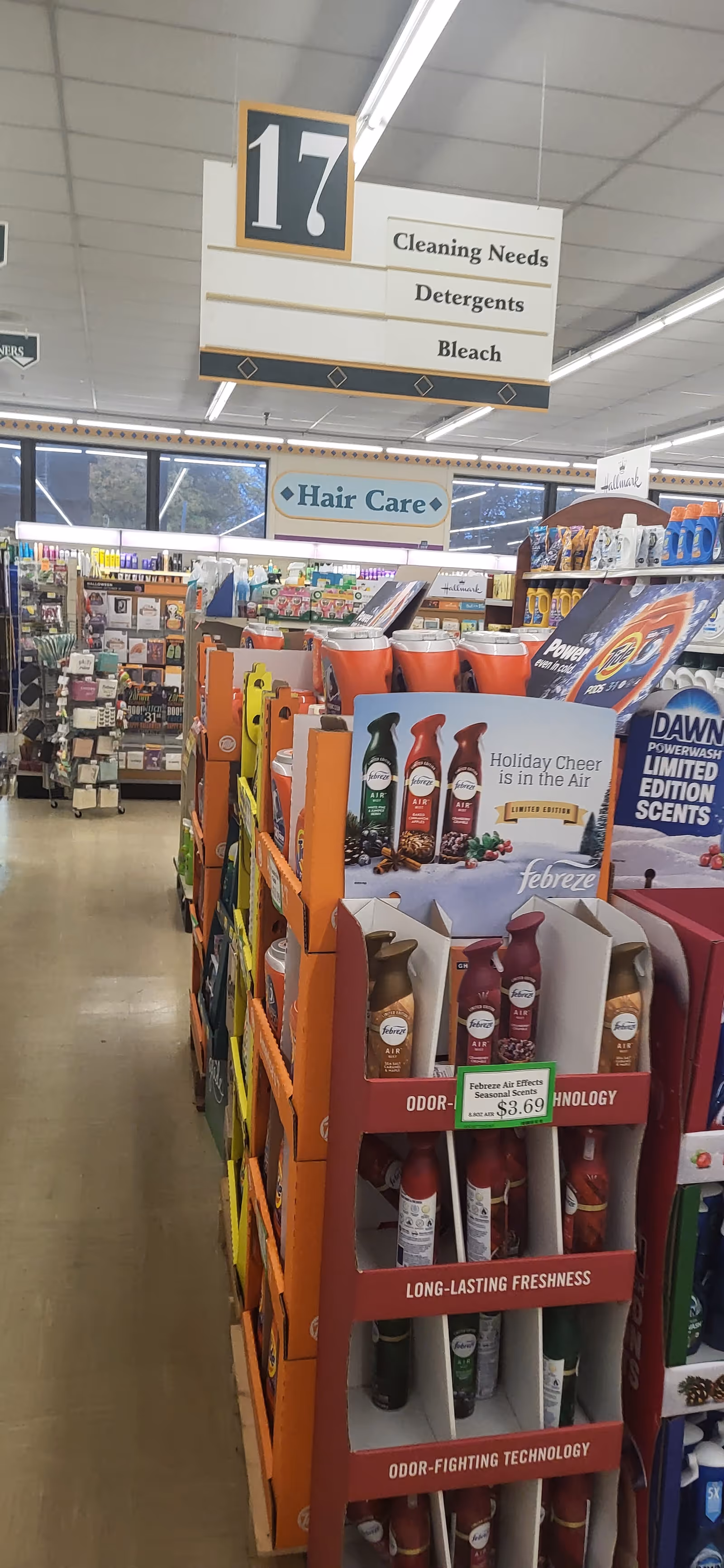 A Discount Drug Mart aisle featuring cleaning supplies, hair care products, and visible signage.