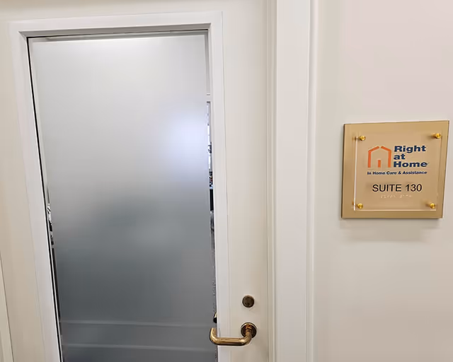 Frosted glass door in a hallway with Right at Home suite plaque.