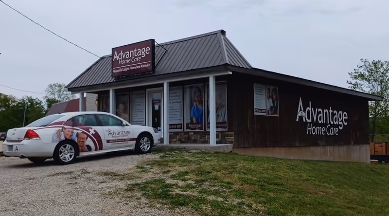 Exterior view of Advantage Home Care facility with a branded car parked outside.