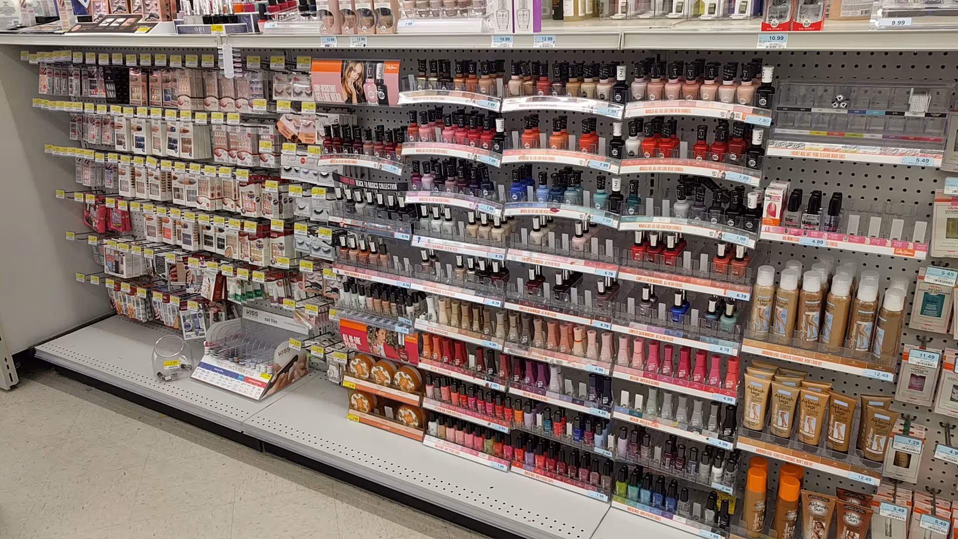 A Discount Drug Mart aisle filled with shelves of nail polish and beauty products.