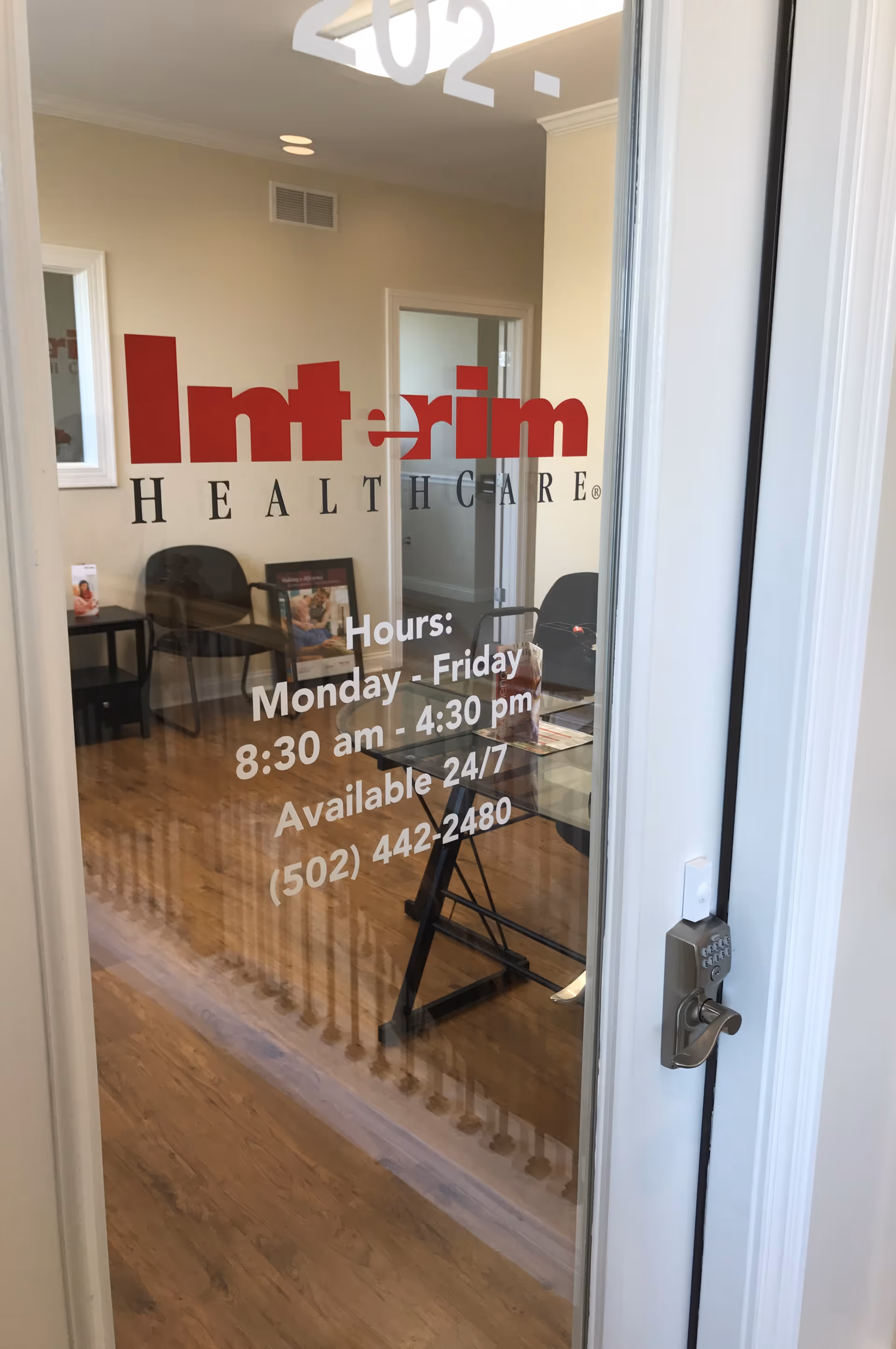 Glass entrance door showing Interim HealthCare Louisville logo and waiting area inside.
