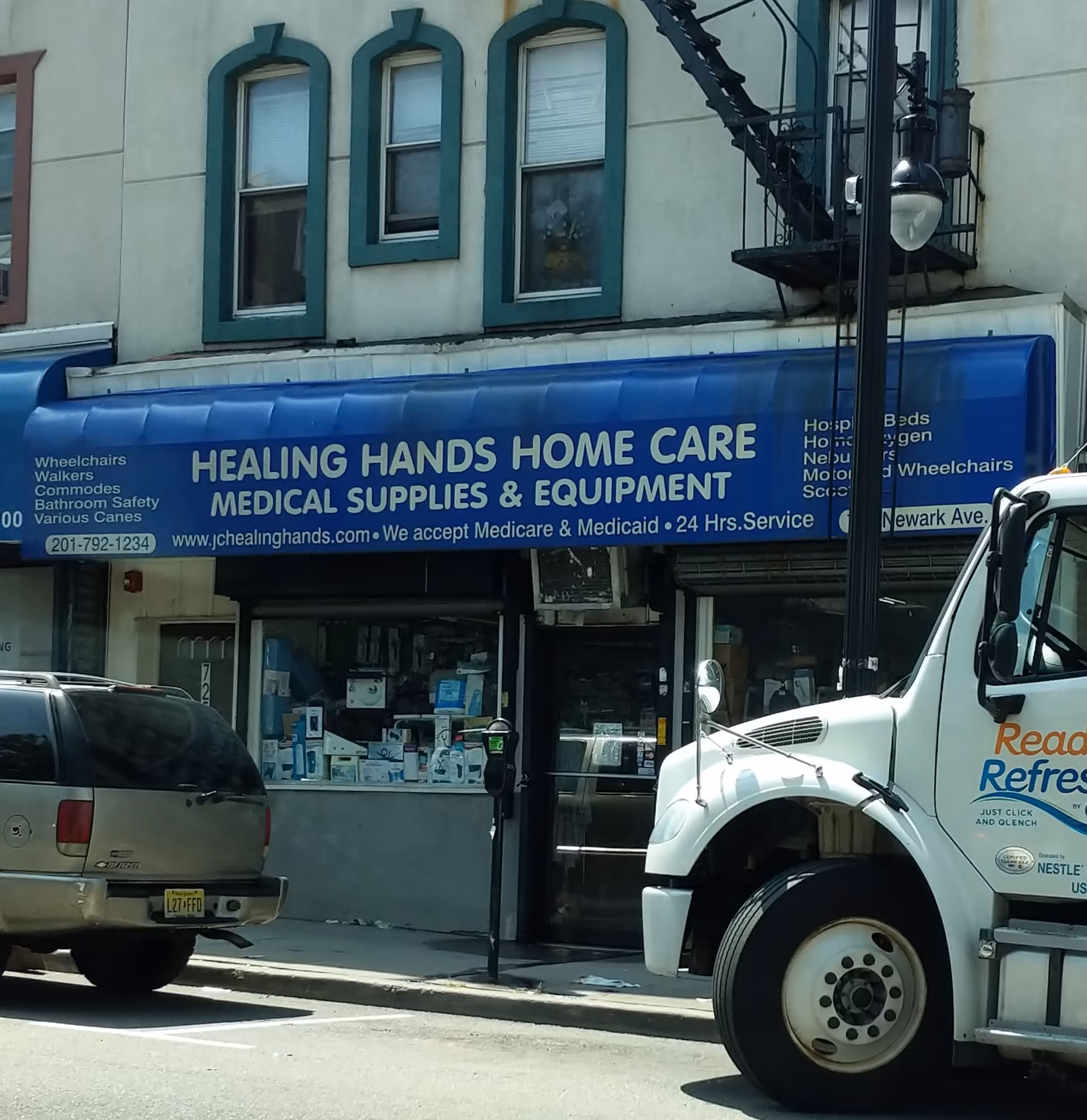 Blue storefront sign reads Healing Hands Home Care Medical Supplies & Equipment on a city street