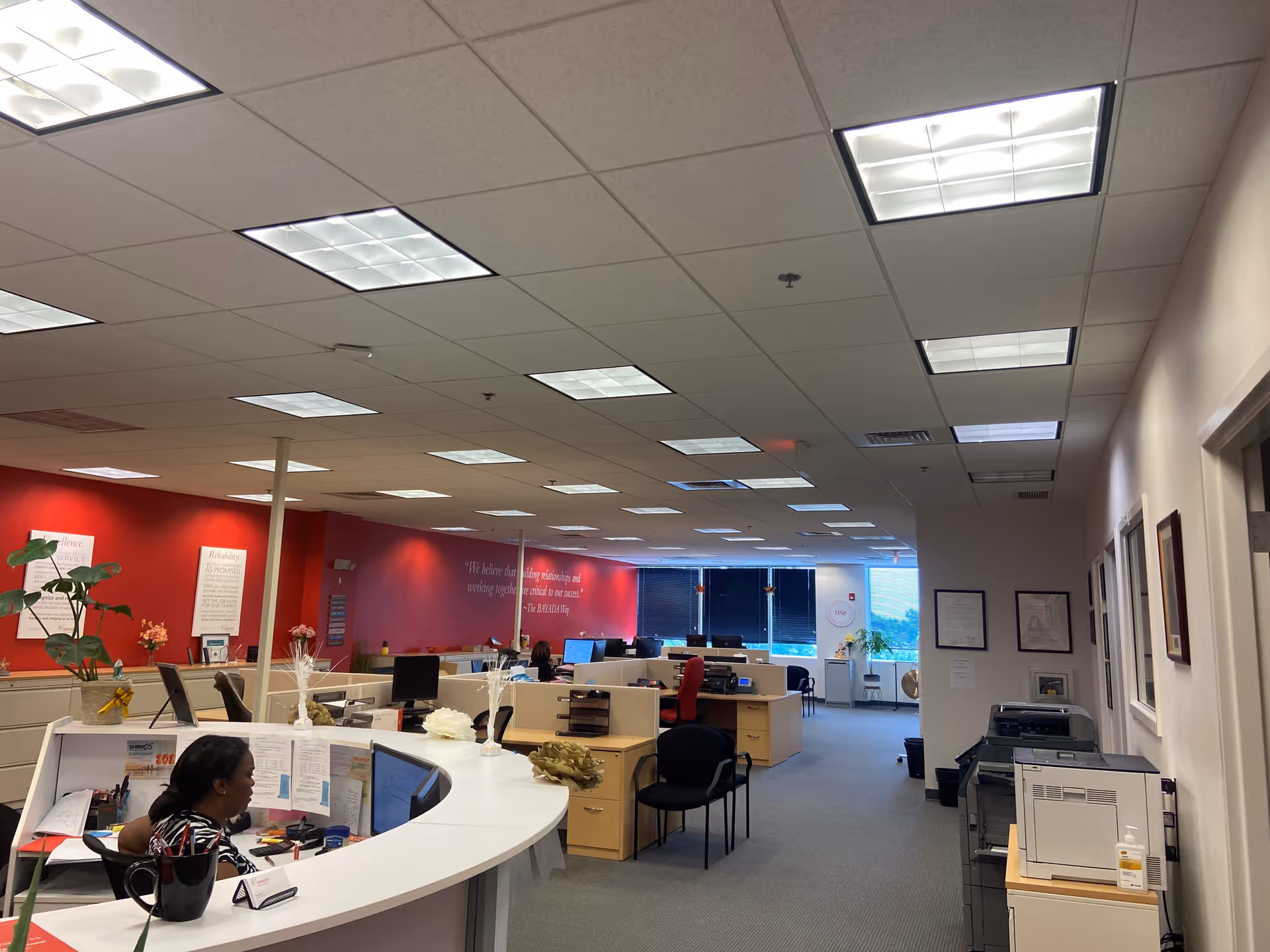 Busy BAYADA Assistive Care office with desks, computers, and staff.