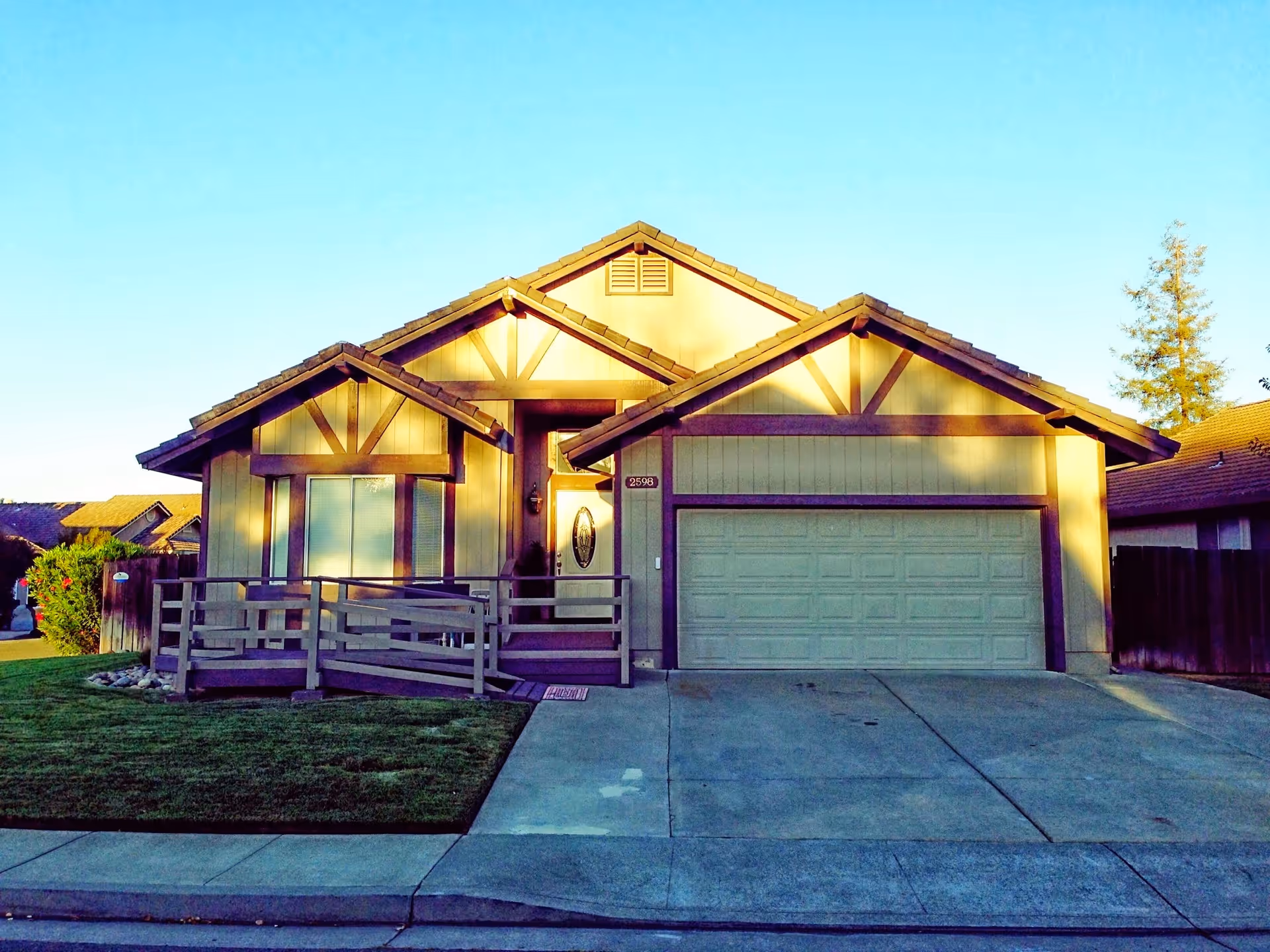 Front exterior view of a single-story care facility with a ramp and attached garage.