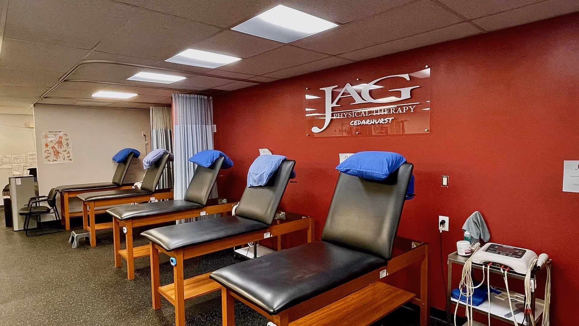 Row of treatment chairs with blue towels in a JAG Physical Therapy clinic