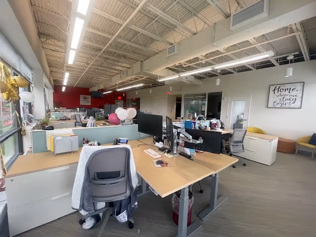 Open-plan interior office area at BAYADA Adult Nursing with desks and computers.
