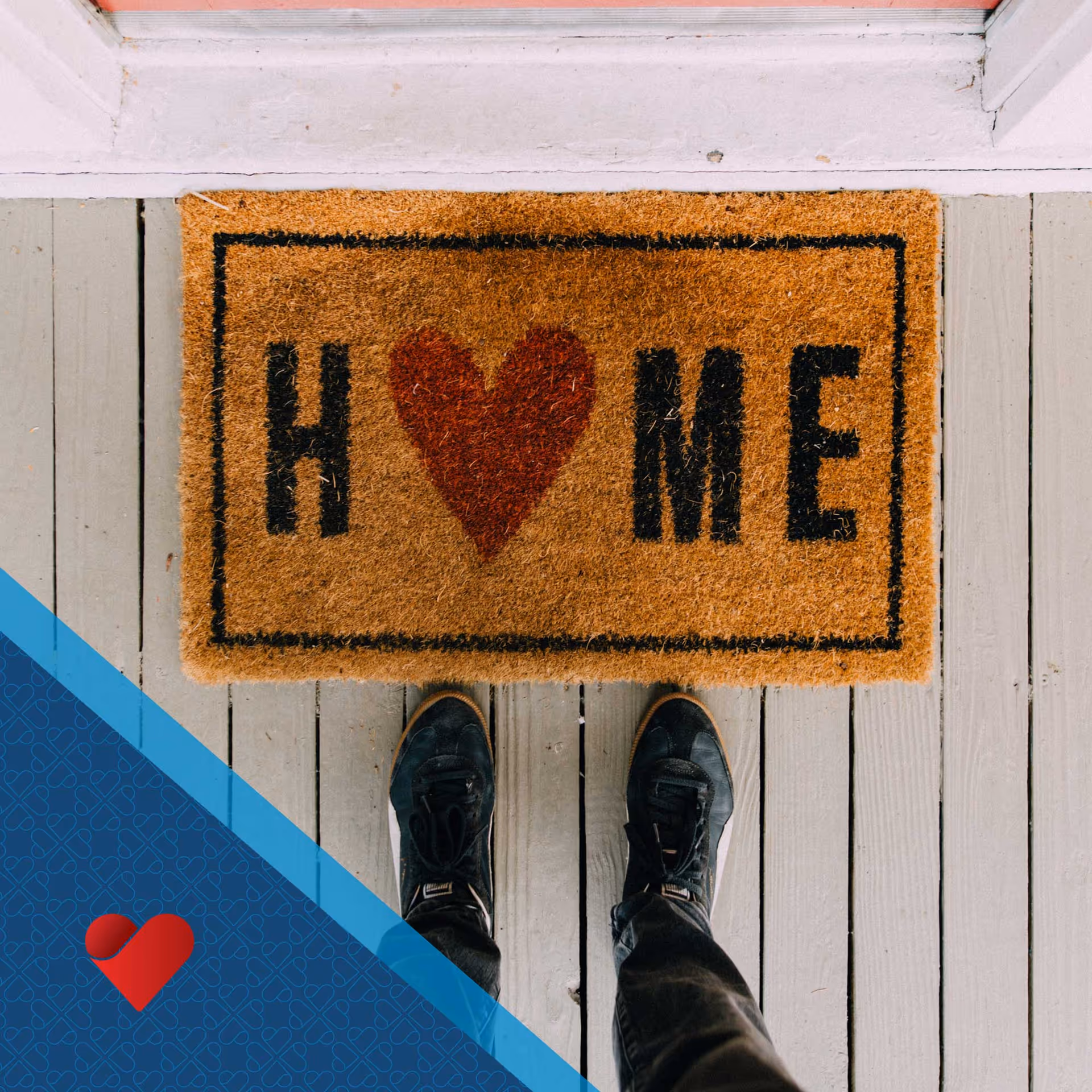 Top-down view of a person standing on a doorstep mat that says HOME with a heart.