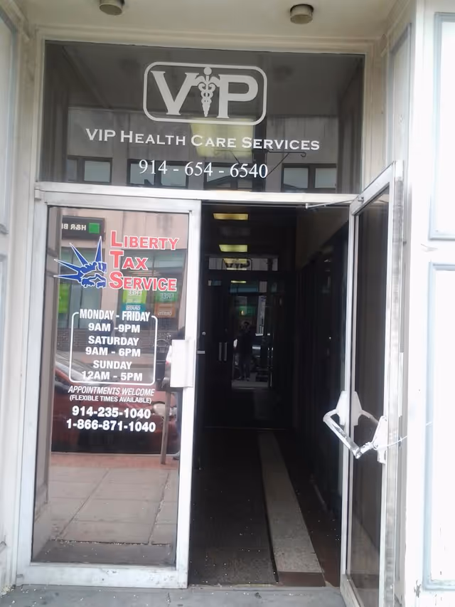 Entrance to a building with glass doors and VIP Health Care Services signage.