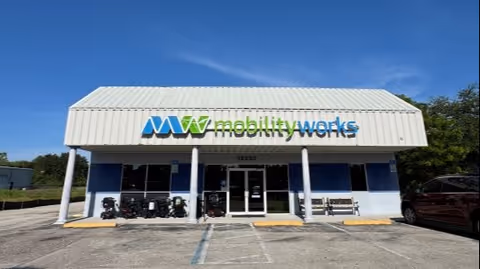 Front exterior of MobilityWorks storefront with blue sign and mobility scooters.