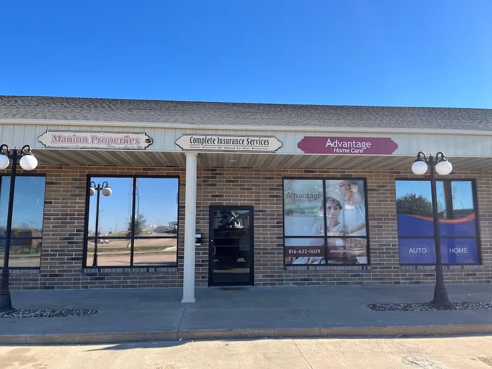 Brick storefront with Advantage Home Care sign and large display windows.