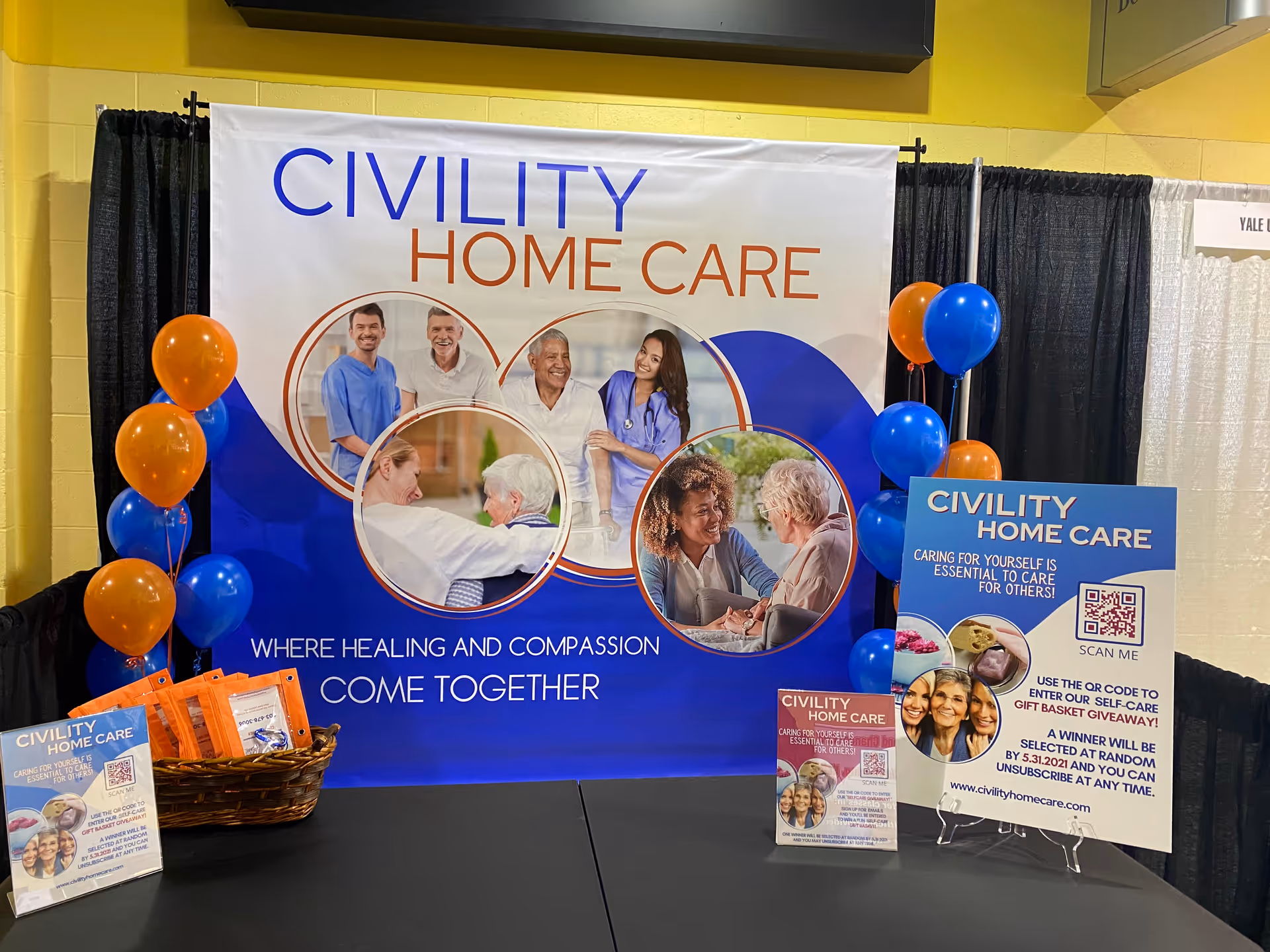 Civility Home Care booth display with large banner, balloons, and informational signage at a trade show.