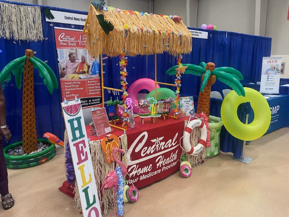 Indoor expo booth for Central Home Health with tropical display and decorations.