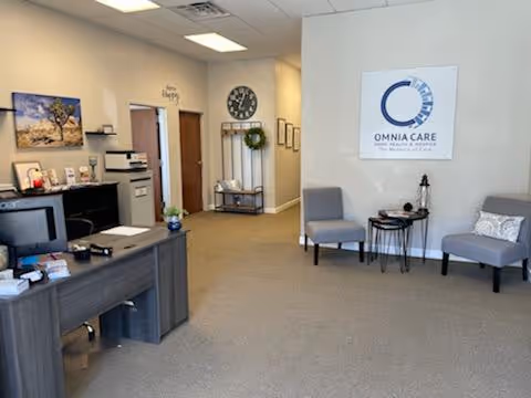 Reception area of OMNIACARE Home Health and Hospice with desk and seating.
