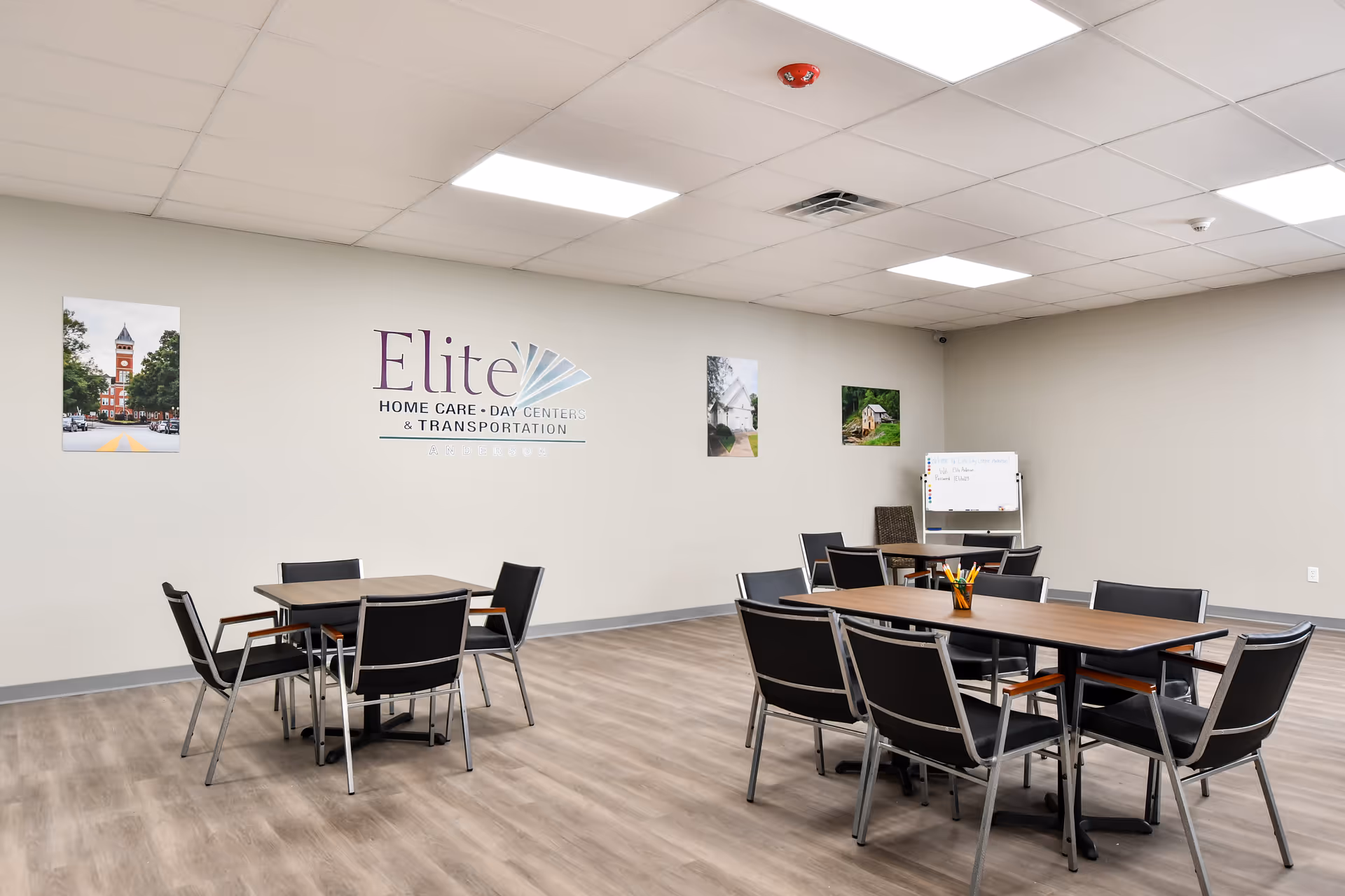 Interior dining area with tables, chairs, and Elite branding on the wall.