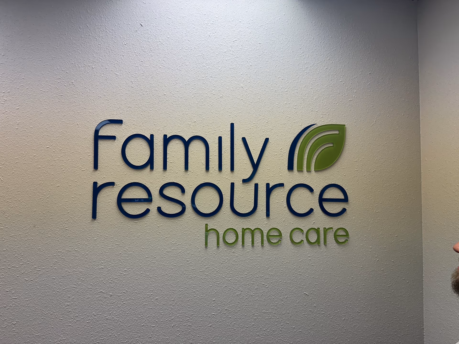 Interior wall with a large Family Resource Home Care sign and logo.