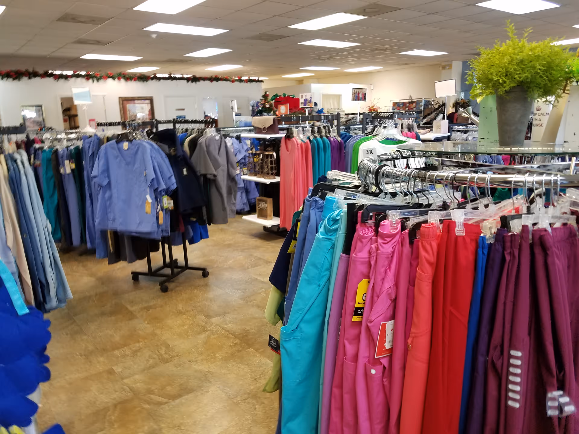 Indoor clothing racks with colorful garments in a well-lit facility.